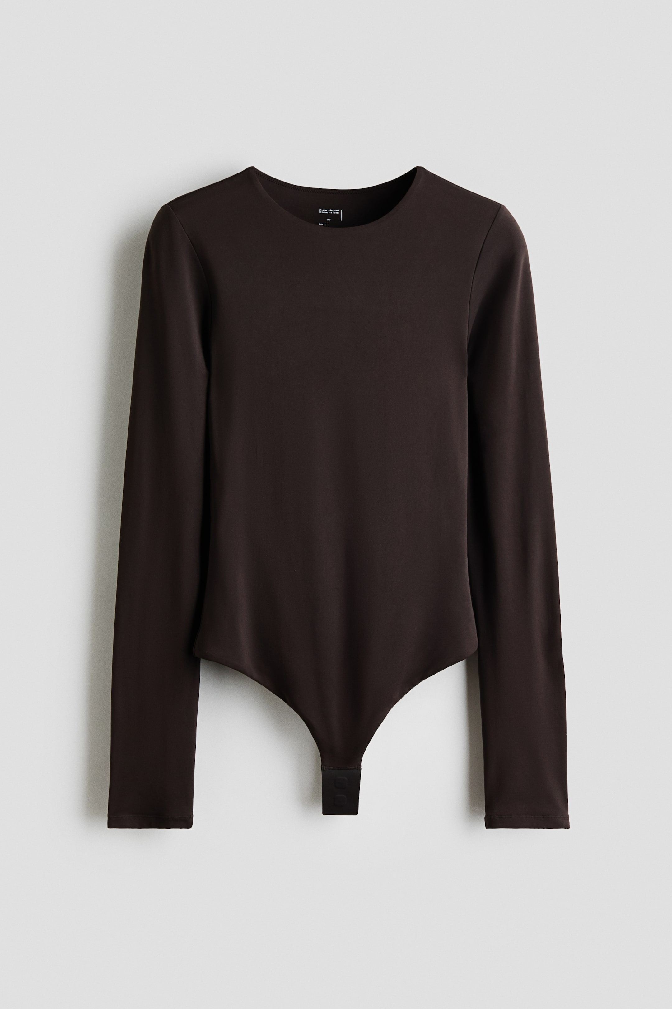 Agrandir l'image: Un body string à manches longues de couleur marron foncé est présenté de face, avec un col rond et des manches longues. Il est doté de boutons-pression dissimulés à l'entrejambe.