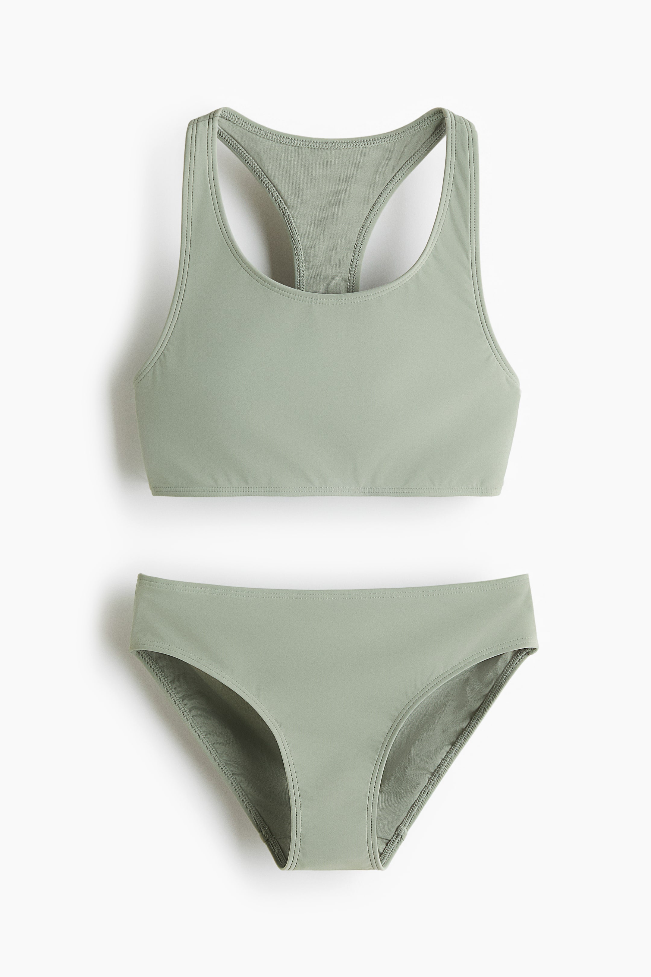 Visa större bild: Ett ljusgrönt tvådelat baddräkt visas med en slät, matt finish. Överdelen har en rundad halsringning och en racerback-design, medan den matchande underdelen är en klassisk bikinibyxa.
