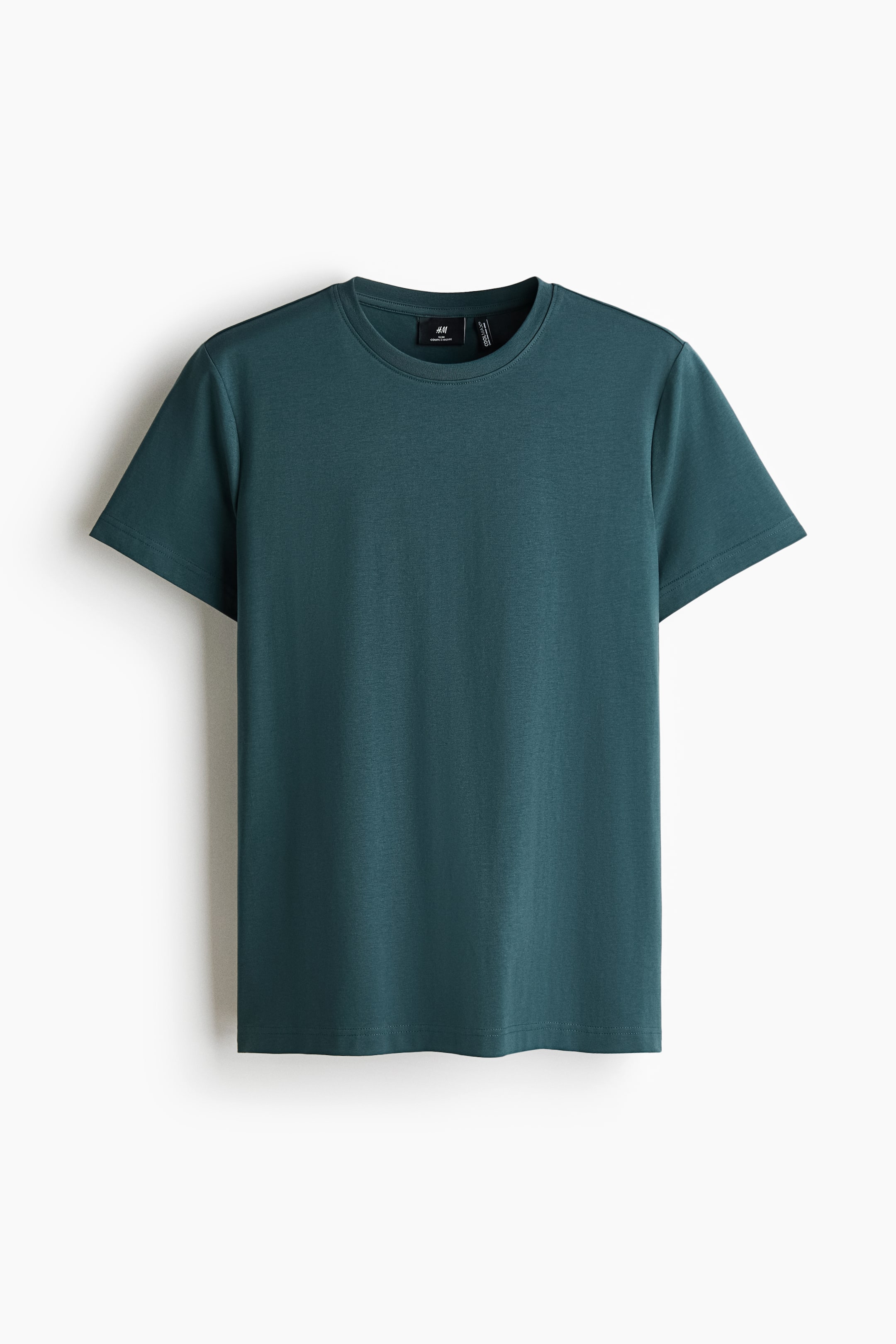 View larger image: A dark teal t-shirt is shown from the front, featuring a crew neck and short sleeves. A brand label is visible on the inside of the back collar.