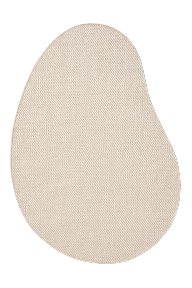 En ljusbeige matta ligger plant och visar upp en oregelbunden, organisk form och en tÃ¤tt vÃ¤vd struktur. - 1