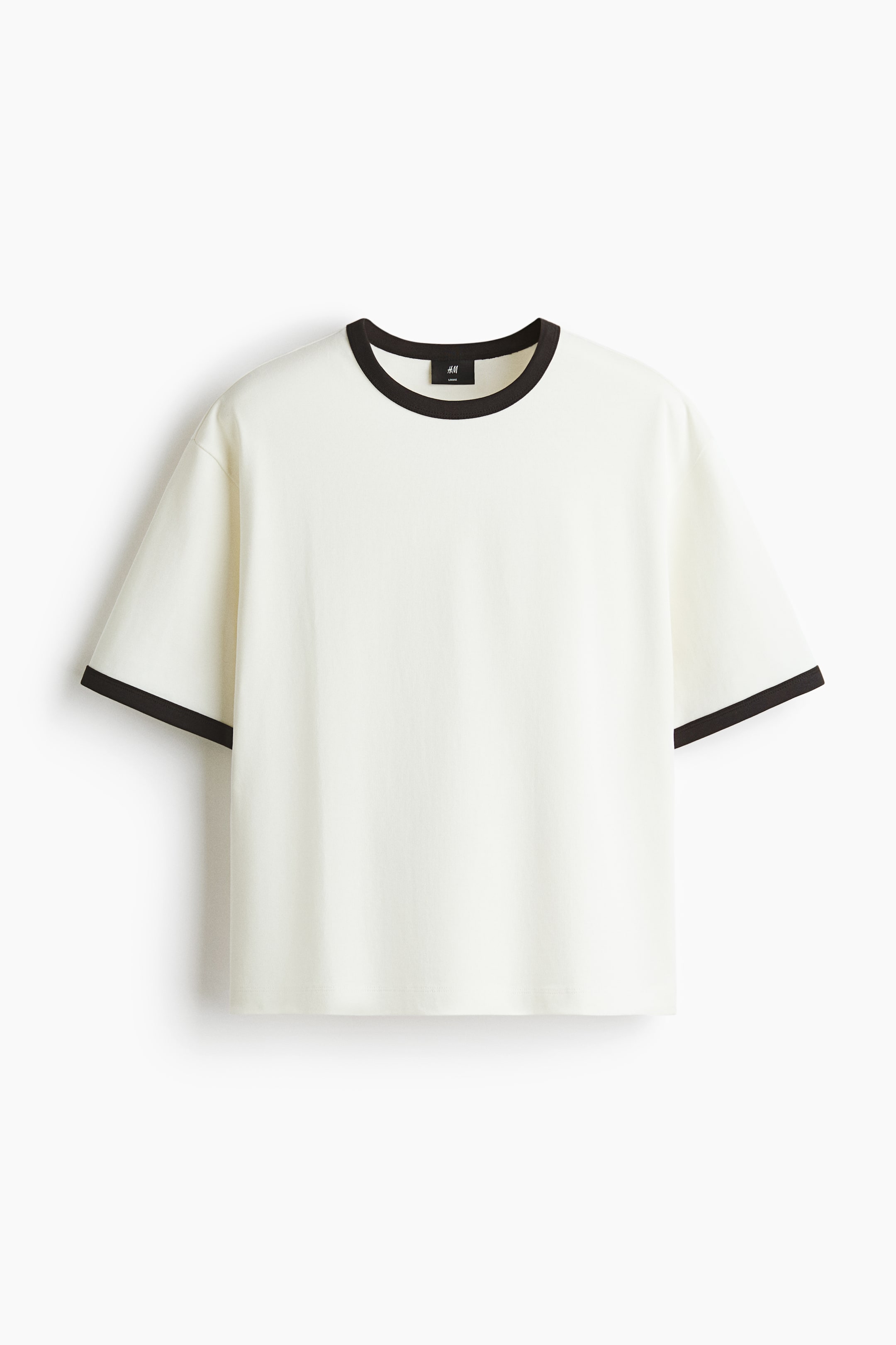 View larger image: A cream-colored t-shirt is presented FRONT, featuring a round neckline and short sleeves. It is detailed with black ribbed trim on the collar and sleeve cuffs.