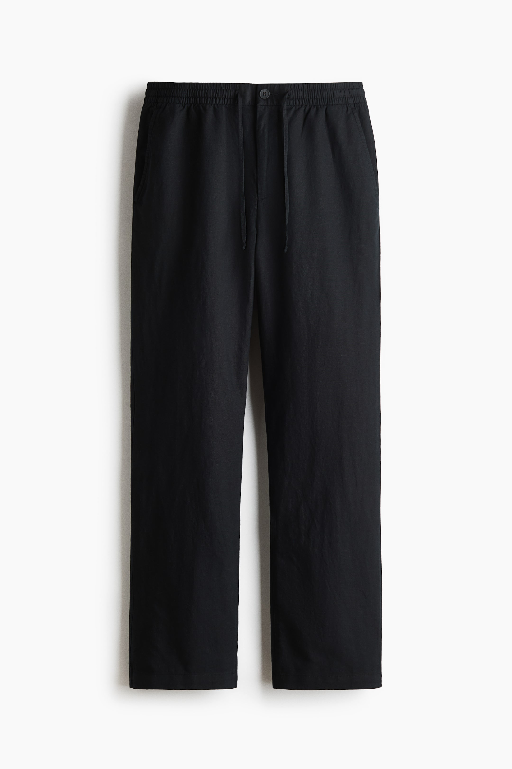 View larger image: The black pants are presented facing FRONT, featuring an elasticated waistband with a drawstring and a button closure. Side pockets are visible, and the pants are designed with a straight-leg fit.