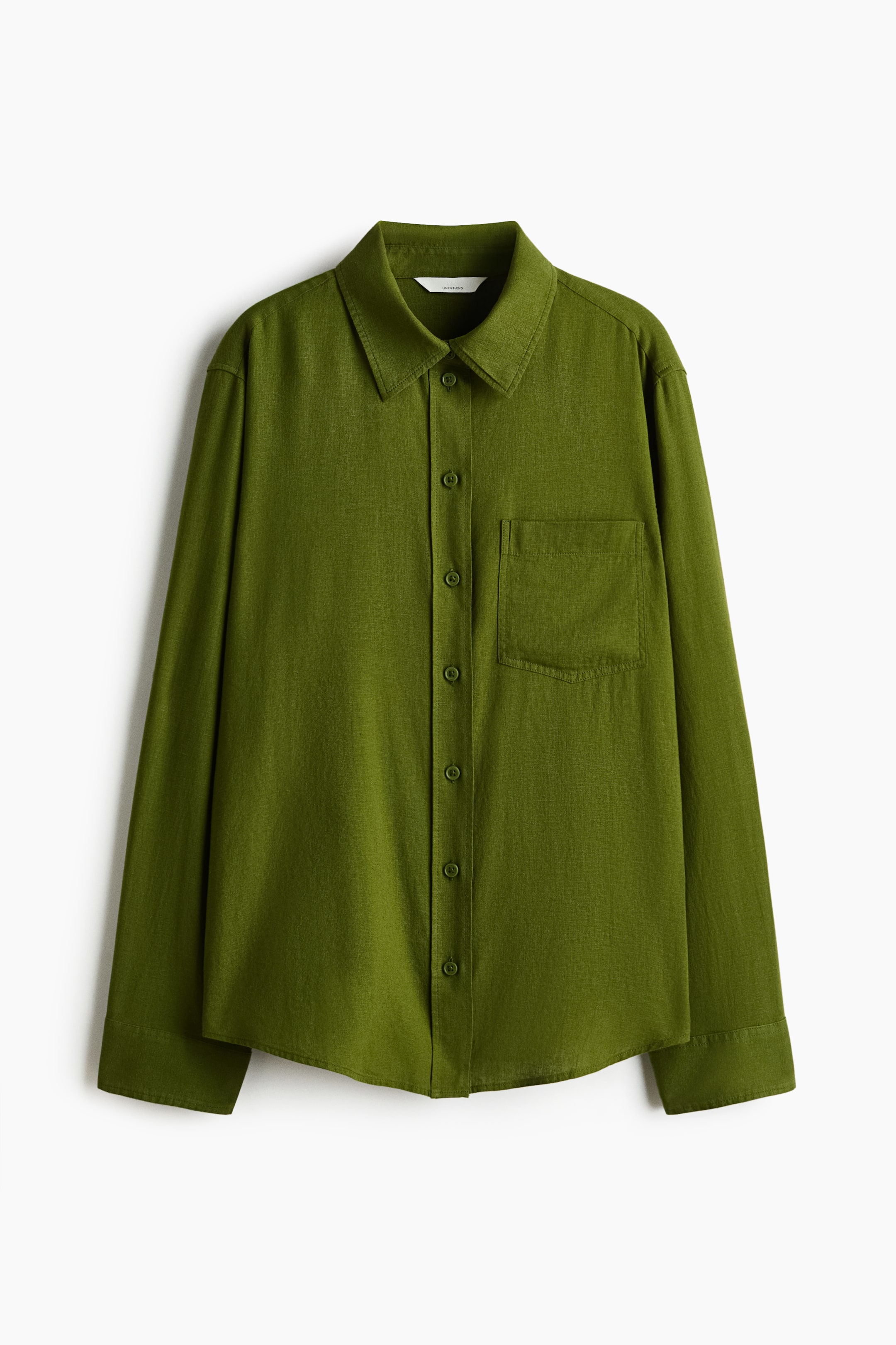 View larger image: An olive green shirt is displayed front-facing, laid flat. It features a pointed collar, a full button placket with matching green buttons, a single patch pocket on the left chest, long sleeves with buttoned cuffs, and a curved hem.