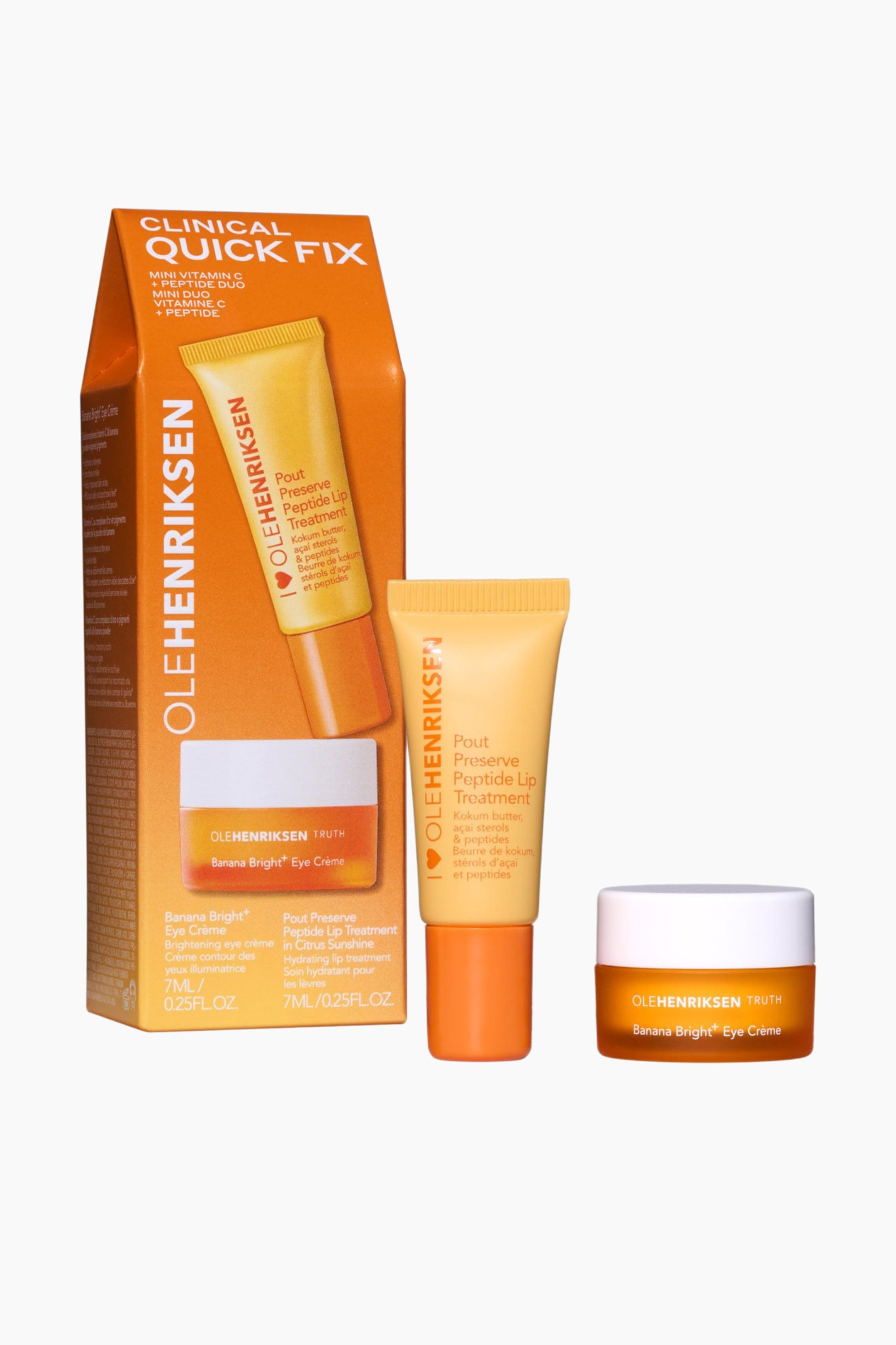 Vis større bilde: Et Ole Henriksen Clinical Quick Fix mini vitamin C and peptide duo-kit vises i en oransje og gul rektangulær eske som står oppreist, med en gul tube med Pout Preserve Peptide Lip Treatment som stikker opp fra toppen og en liten oransje krukke med Banana Bright+ Eye Crème synlig gjennom en nedre utskjæring. Identiske enkeltstående tuber og krukker står også oppreist ved siden av esken.