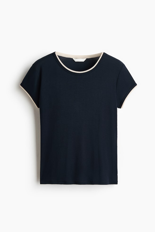 This dark navy short-sleeved t-shirt is facing front, featuring a crew neckline and sleeve cuffs with contrasting cream-colored ringer trim. - 1