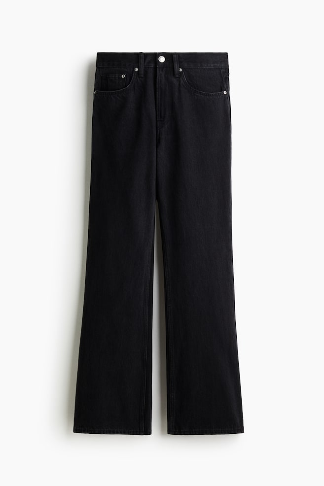 A pair of black denim jeans is being displayed from the front, featuring a straight-leg cut and a waistband with visible belt loops. A silver-toned button and zipper fly closure, along with two rounded front pockets with rivets and a small coin pocket, are also visible. - 1