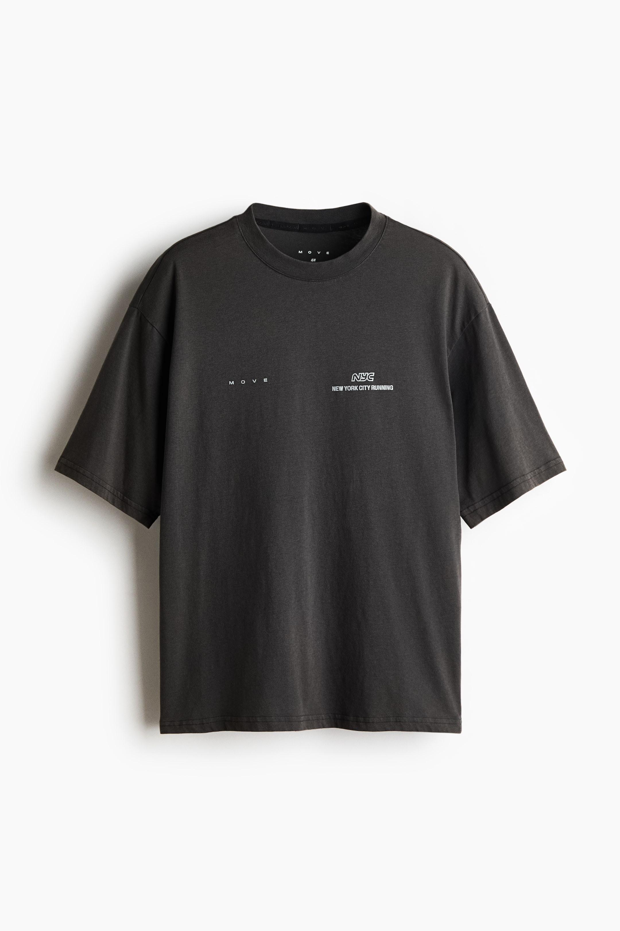 View larger image: A dark gray, relaxed-fit T-shirt is shown from the front, featuring a crew neck and dropped shoulders. It displays small white printed graphics on the chest, with "MOVE" on the right side and "NYC NEW YORK CITY RUNNING" on the left.