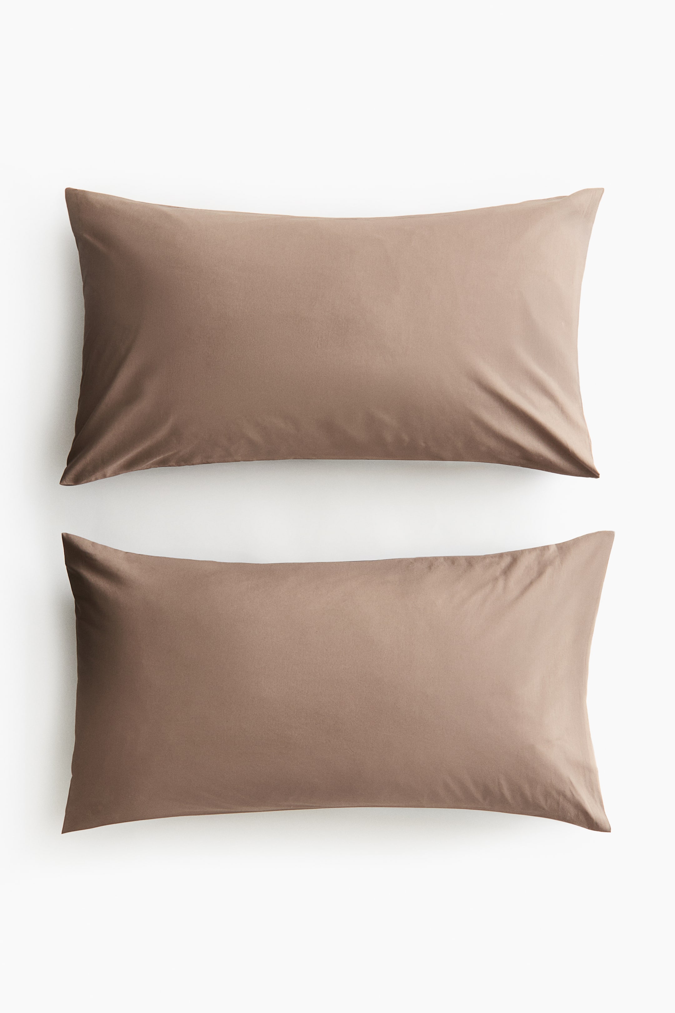 View larger image: A pair of rectangular pillowcases showcasing a muted brown colour and a smooth, soft cotton weave. They are laid flat, with the front view visible, and each pillowcase is designed with an envelope opening.