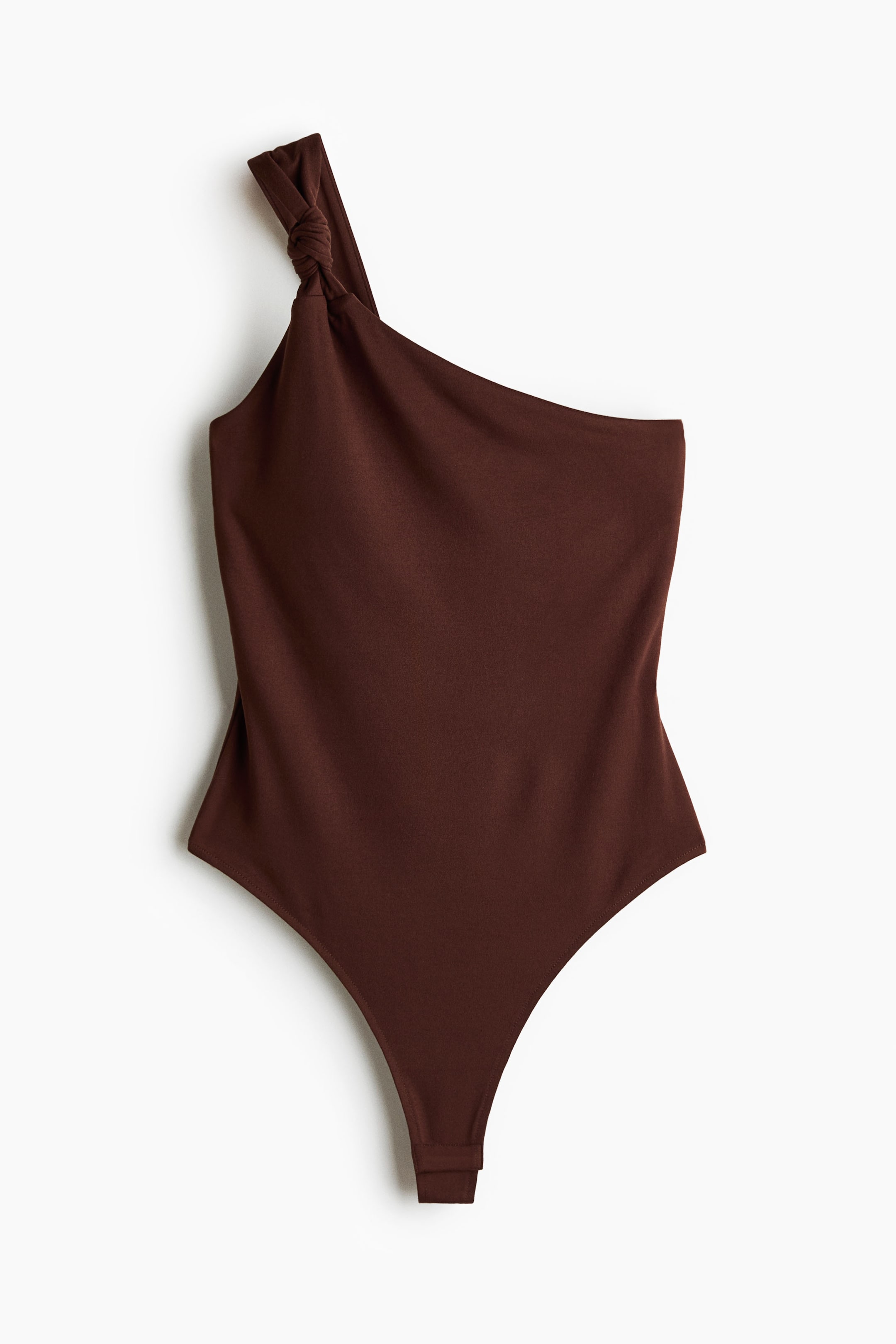 View larger image: A brown one-shoulder thong bodysuit in soft jersey is showcased from the front, highlighting its asymmetric neckline. A wide shoulder strap features a knot detail at the front, while a thong cut defines the bottom.