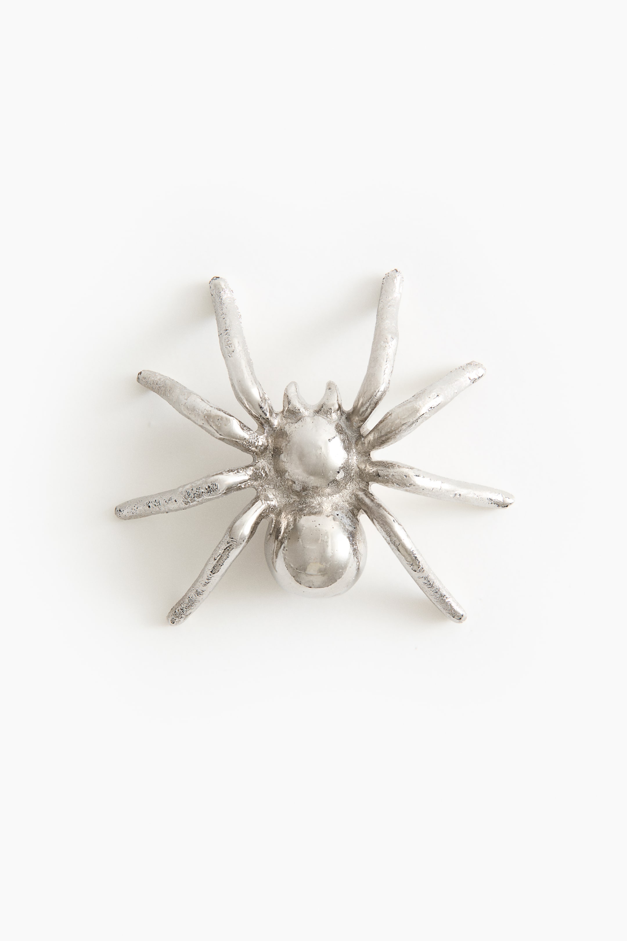View larger image: A silver-toned metallic spider is shown from its dorsal side, featuring eight splayed legs with a textured finish and a smooth, rounded abdomen.