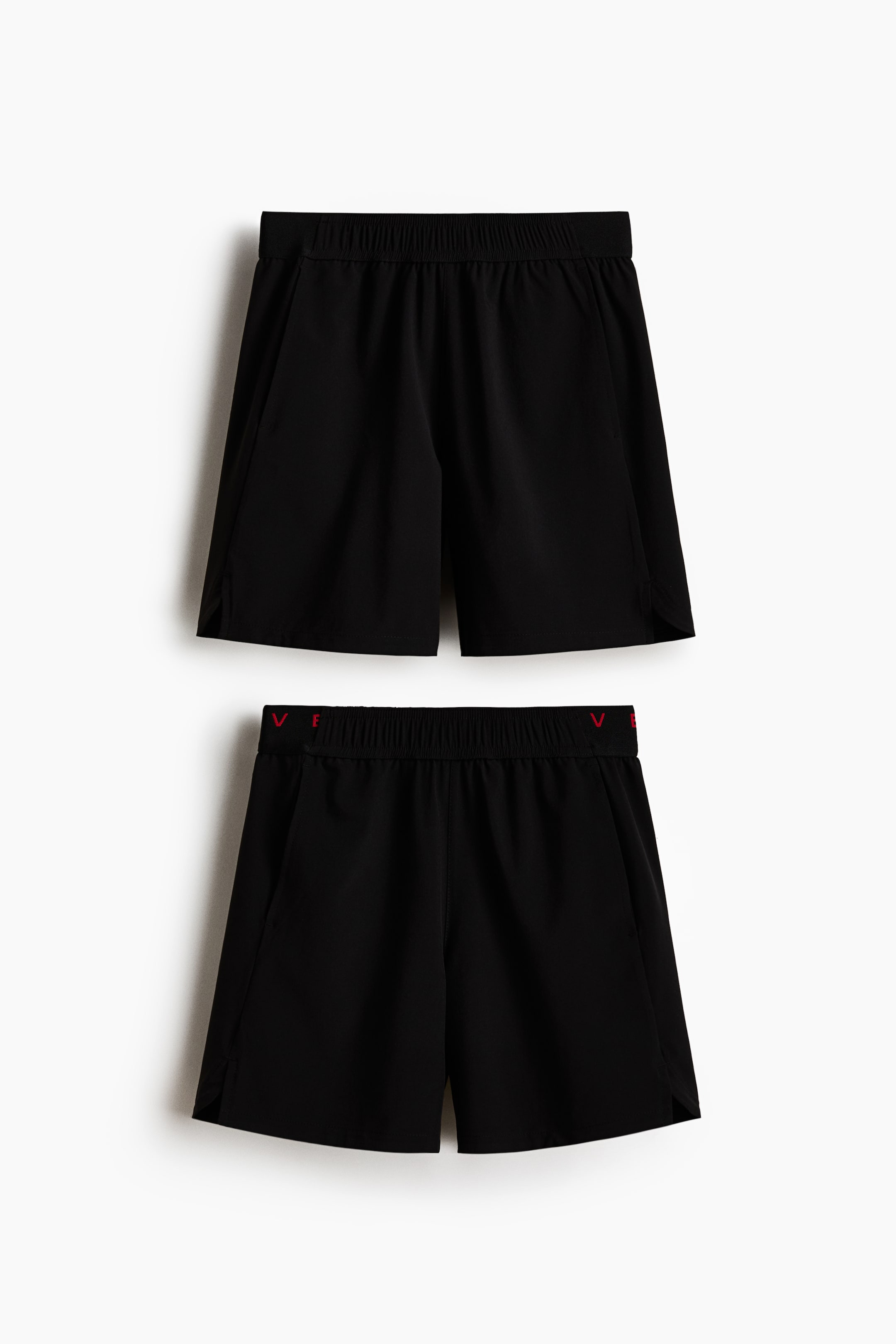 View larger image: Each pair is featuring an elasticated waistband, side pockets, and small side slits at the hem, while the bottom pair is also displaying a red inscription along the inside of its waistband.