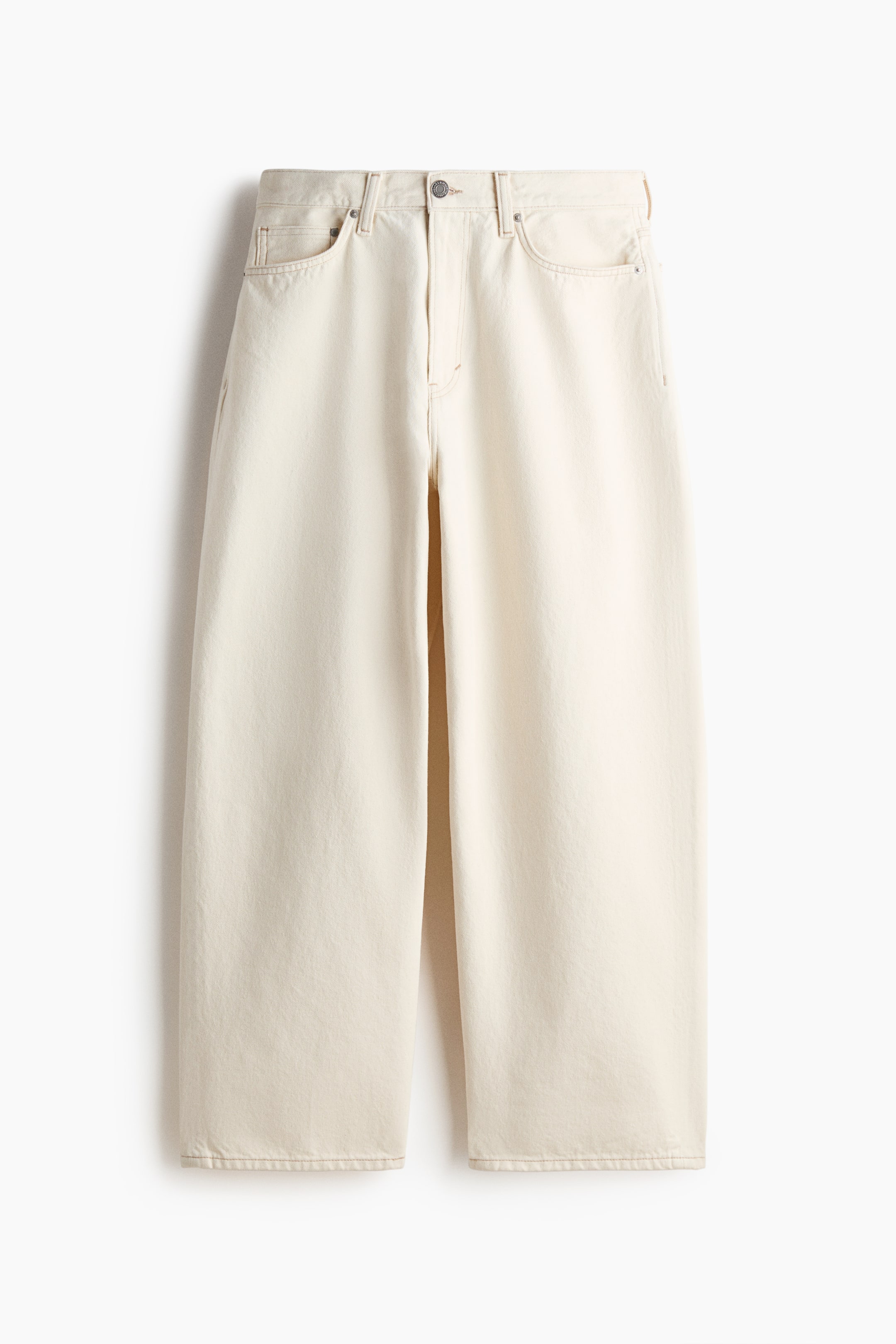 View larger image: Cream wide-leg jeans are showcased front-facing. They feature a visible waistband with belt loops, a single metal button closure, and a zipper fly. Two scoop pockets are visible at the front hips, along with a small coin pocket, and the wide legs fall straight to the hem.