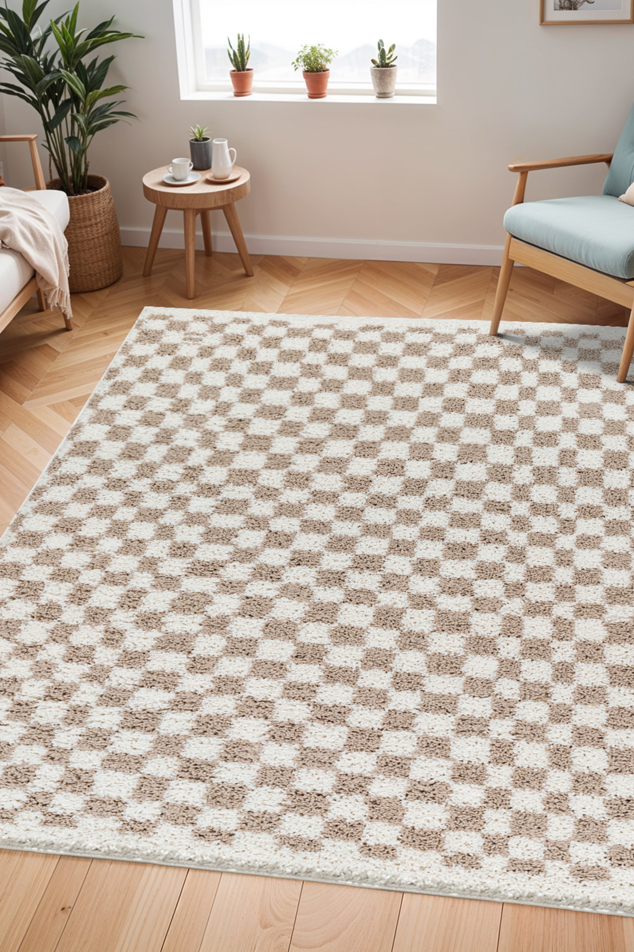View larger image: The rug exhibits a chequerboard pattern with alternating squares in cream and light brown, featuring a shaggy texture. It is laid flat on a wooden floor, viewed from an overhead angle.