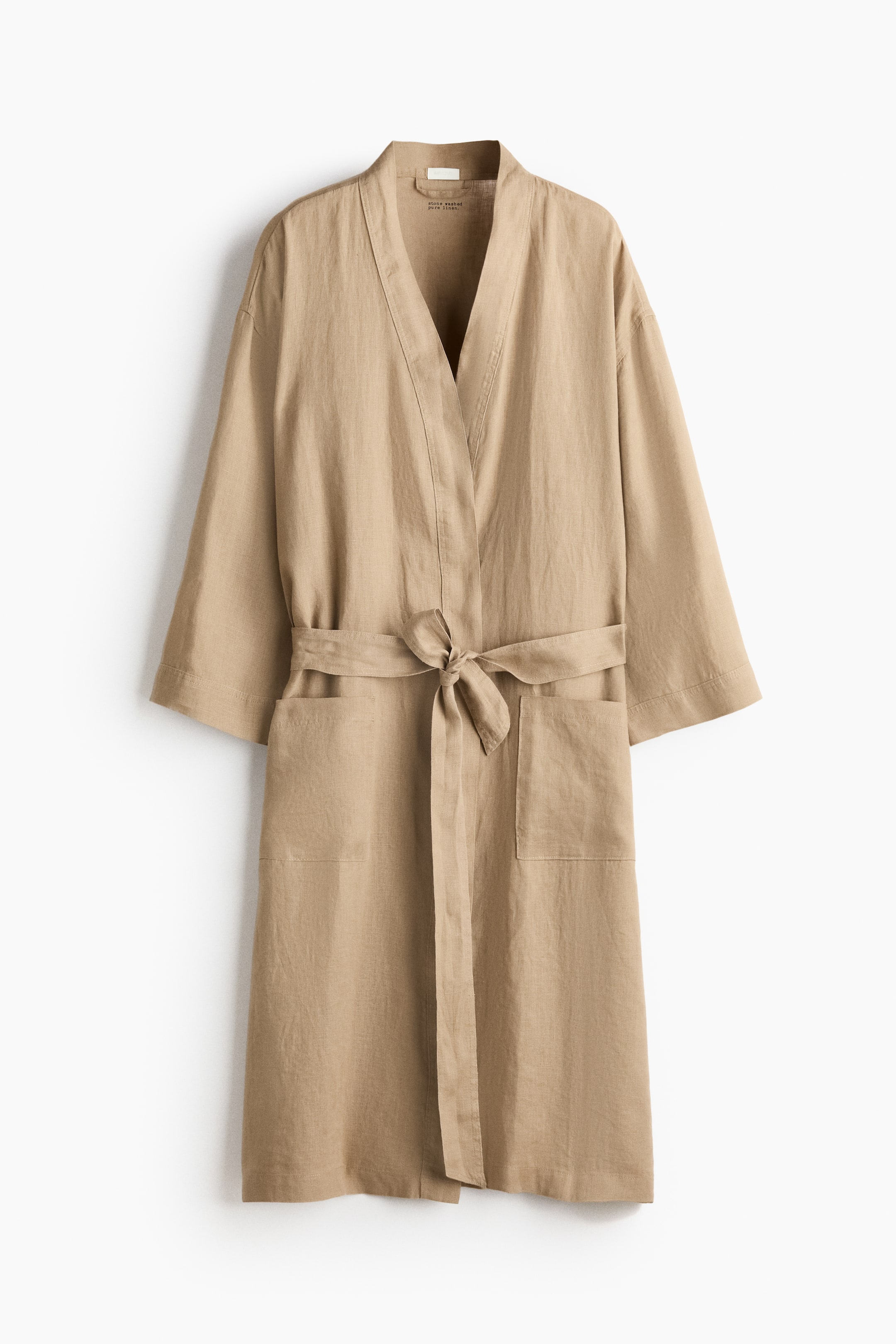 View larger image: A natural beige washed linen dressing gown is presenting FRONT, featuring a V-neck opening, wide sleeves, two front patch pockets, and a detachable tie belt tied at the waist.