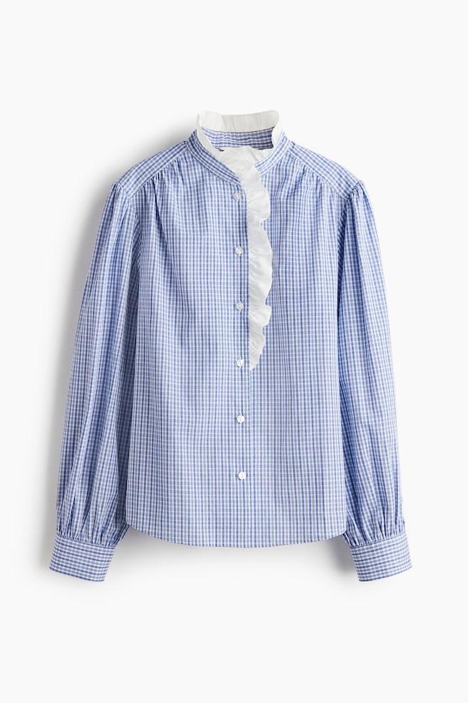 A blue and white gingham check shirt is presenting its front, featuring a white ruffled placket with white buttons. It is designed with a ruffled standing collar and long sleeves that are gathering into buttoned cuffs. - 1