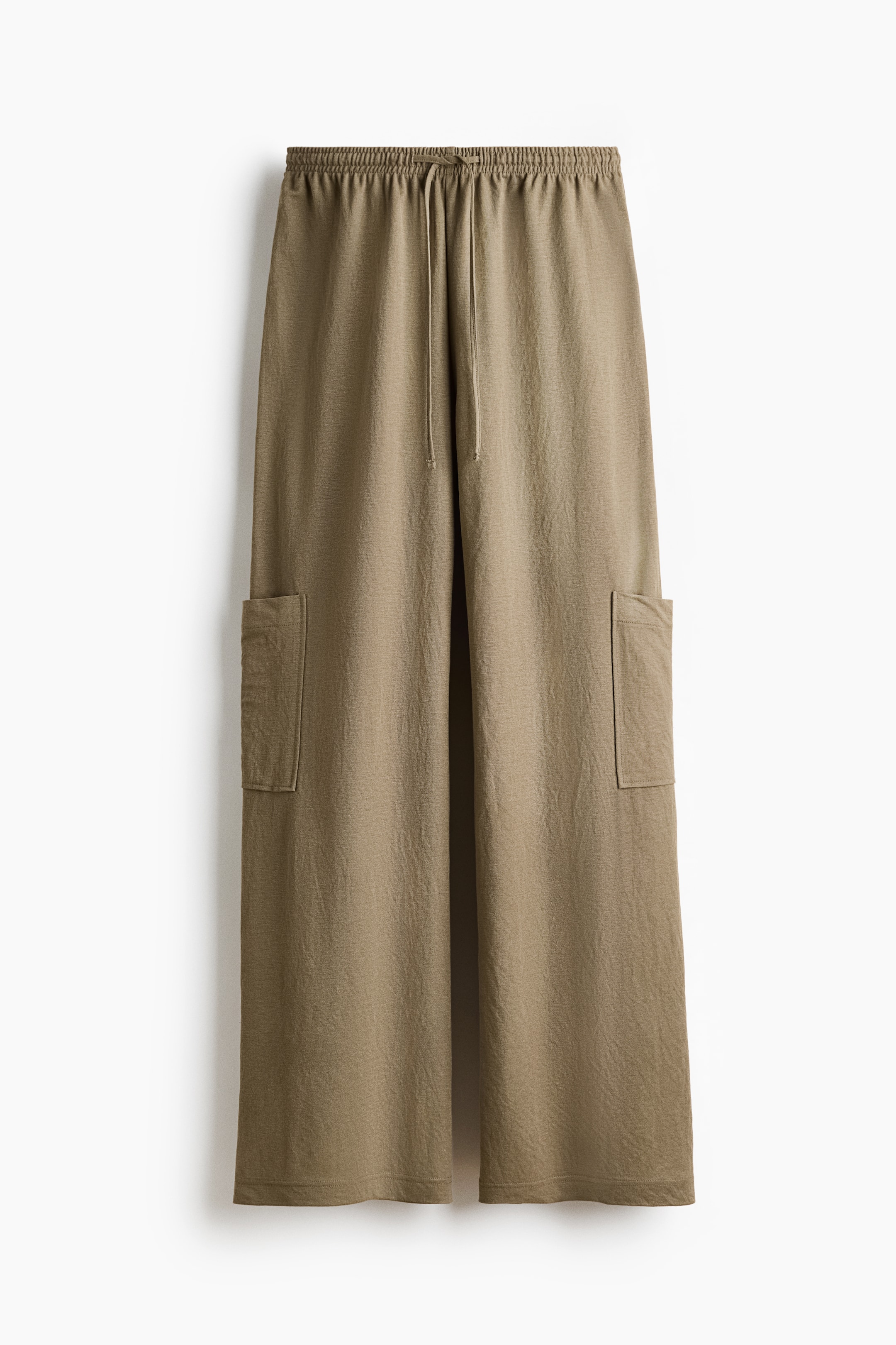 View larger image: Olive green wide-leg pants are positioned facing forward, showcasing an elastic drawstring waistband and two rectangular patch pockets, one on each outer thigh. The fabric exhibits a subtly crinkled texture.