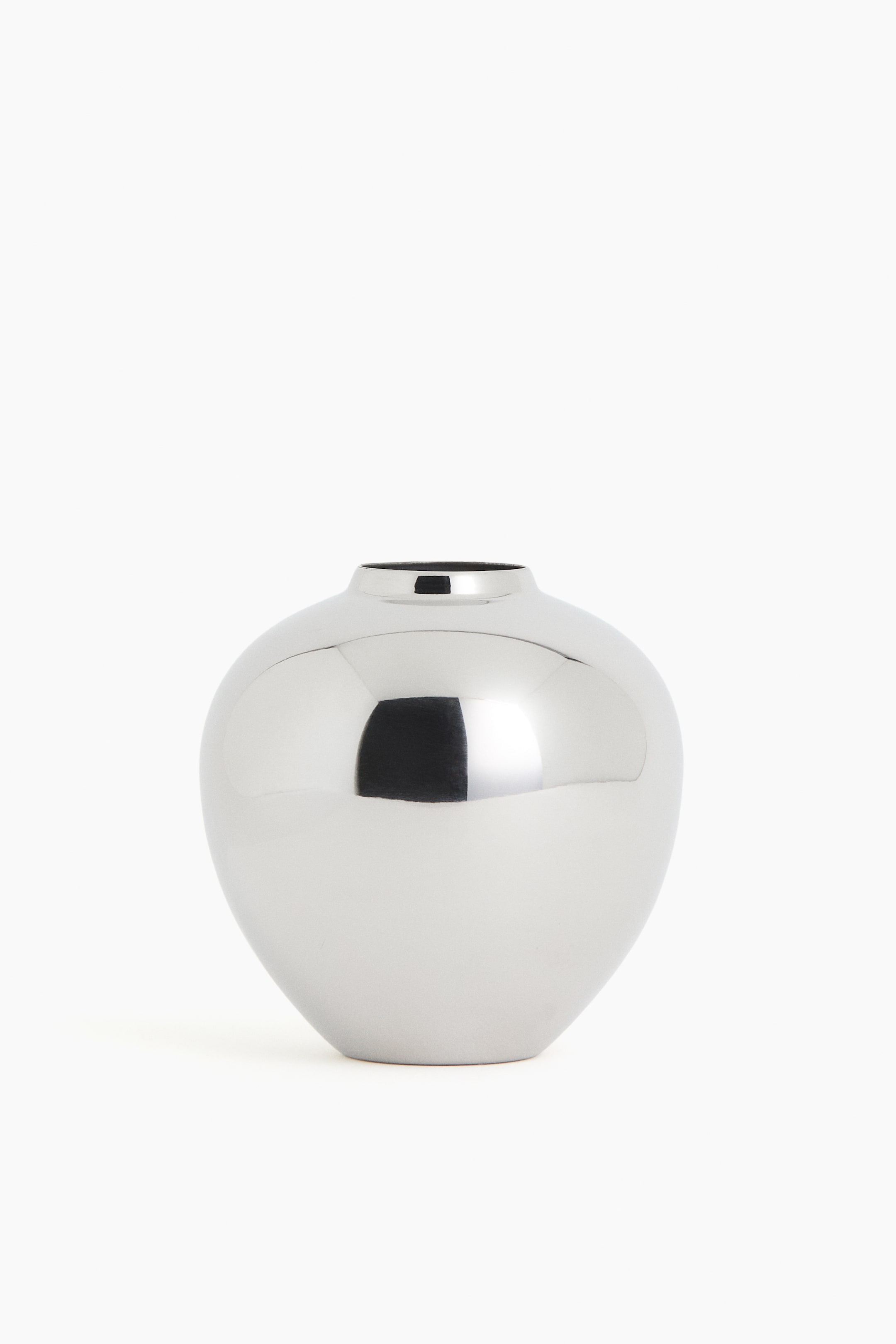 View larger image: A silver vase showcases a polished, reflective finish. Its rounded, bulbous body tapers to a narrow opening at the top and rests on a flat base.