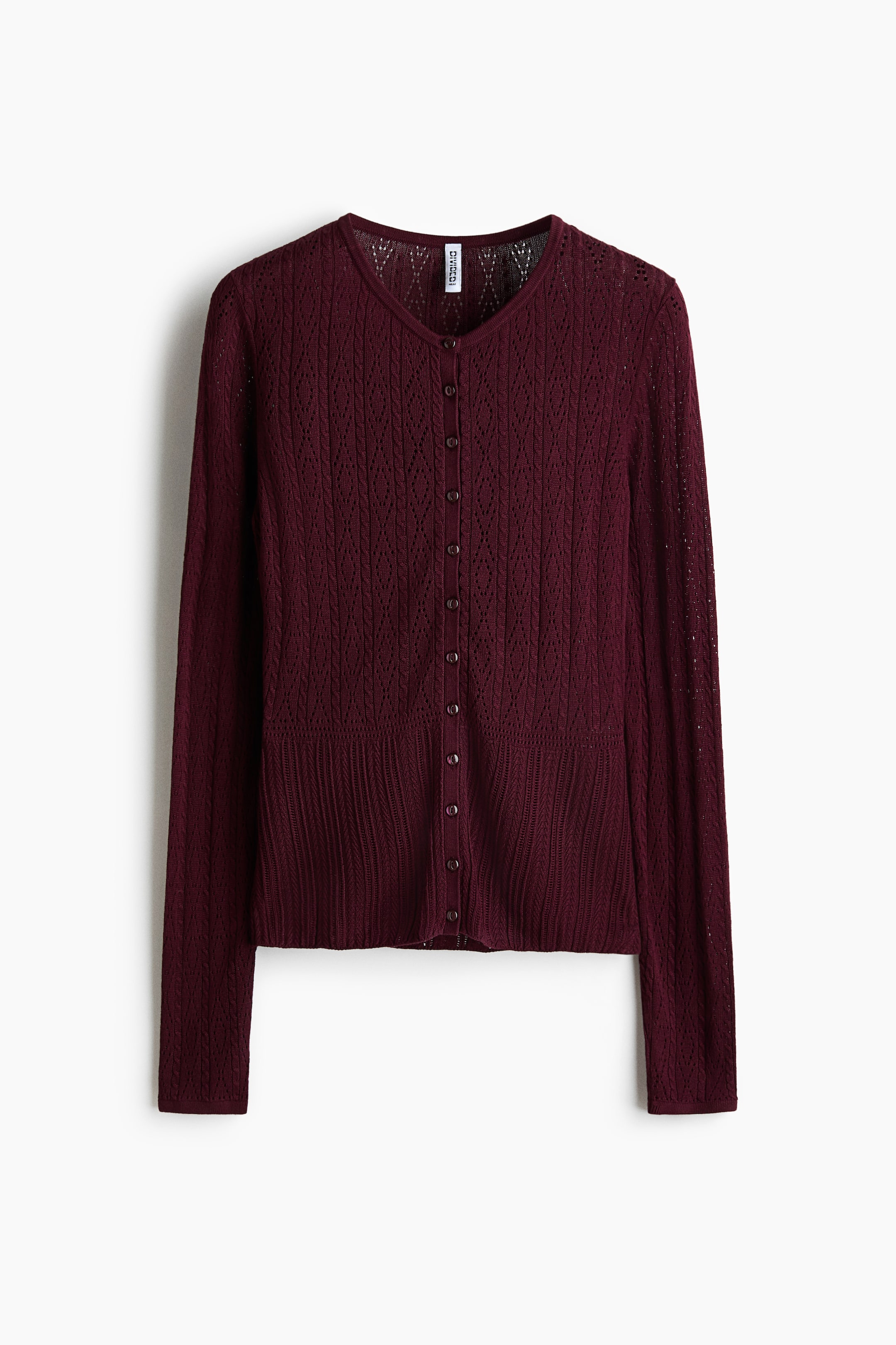 View larger image: A dark red cardigan shows its front, with a V-neck and a full button-front closure secured by small, dark buttons. An intricate open-knit diamond pattern extends across the body and long sleeves, finished with a ribbed hem.