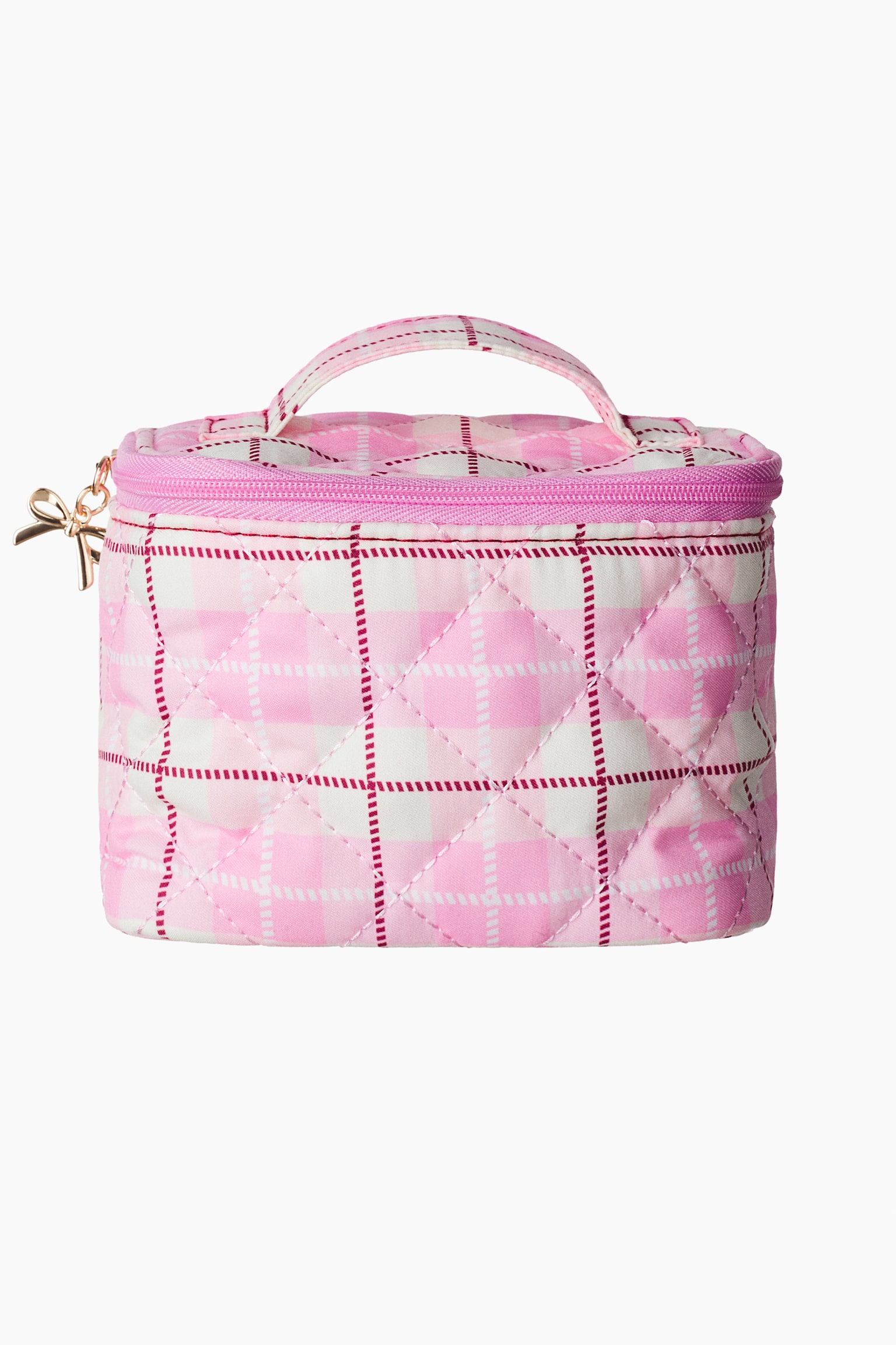 A pink and white quilted cosmetic bag is shown from the front, showcasing a plaid pattern with thin red dashed lines and a diamond-stitched texture. The bag features a matching top handle, a pink zip-around closure, and a gold-tone bow-shaped zipper pull on the side.