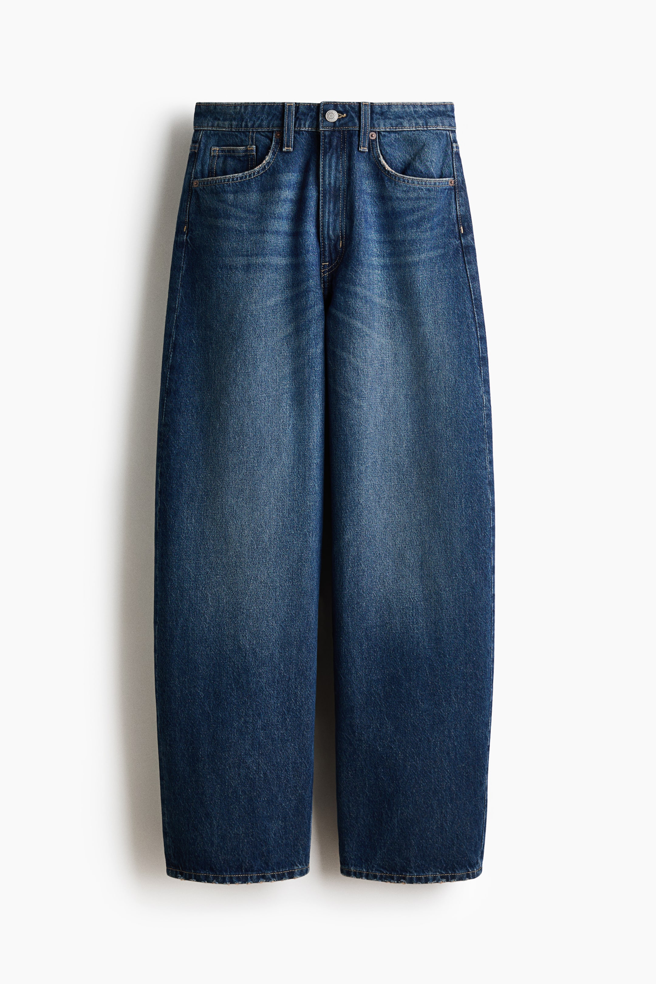 View larger image: Blue denim wide-leg jeans showcase a washed finish and a front button closure with a zipper fly. They also feature belt loops and two front scoop pockets, including a small coin pocket.