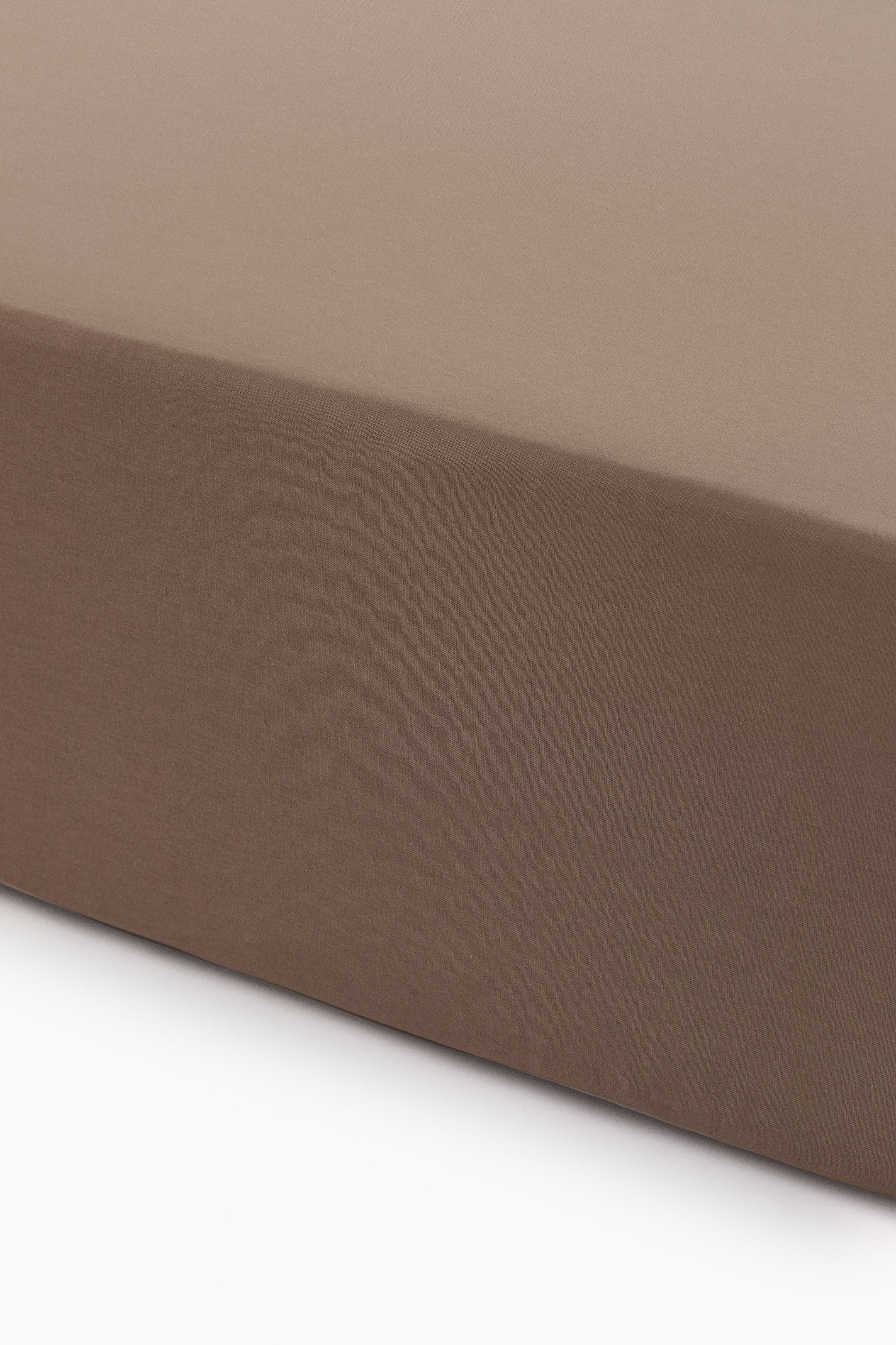 View larger image: A brown fabric covers a rectangular object, displaying a smooth, taut texture on its flat top surface and vertical side.