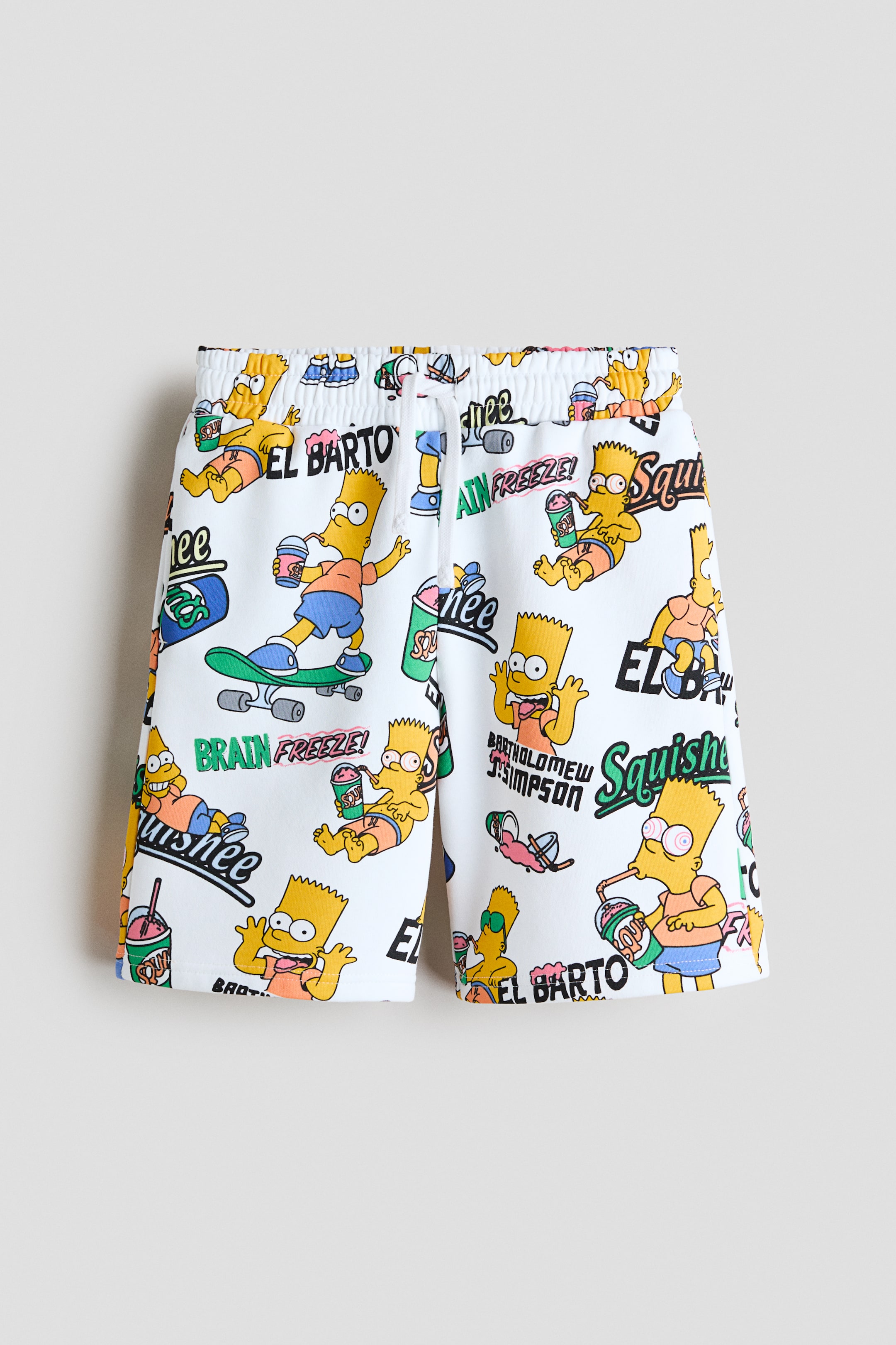 View larger image: Knee-length, loose-fit shorts are showcased at the front, boasting an all-over white print featuring multiple Bart Simpson characters in various poses, accompanied by text such as 'EL BARTO' and 'BRAIN FREEZE!'. The shorts feature an elasticated waist with a white drawstring and subtle side pocket openings.