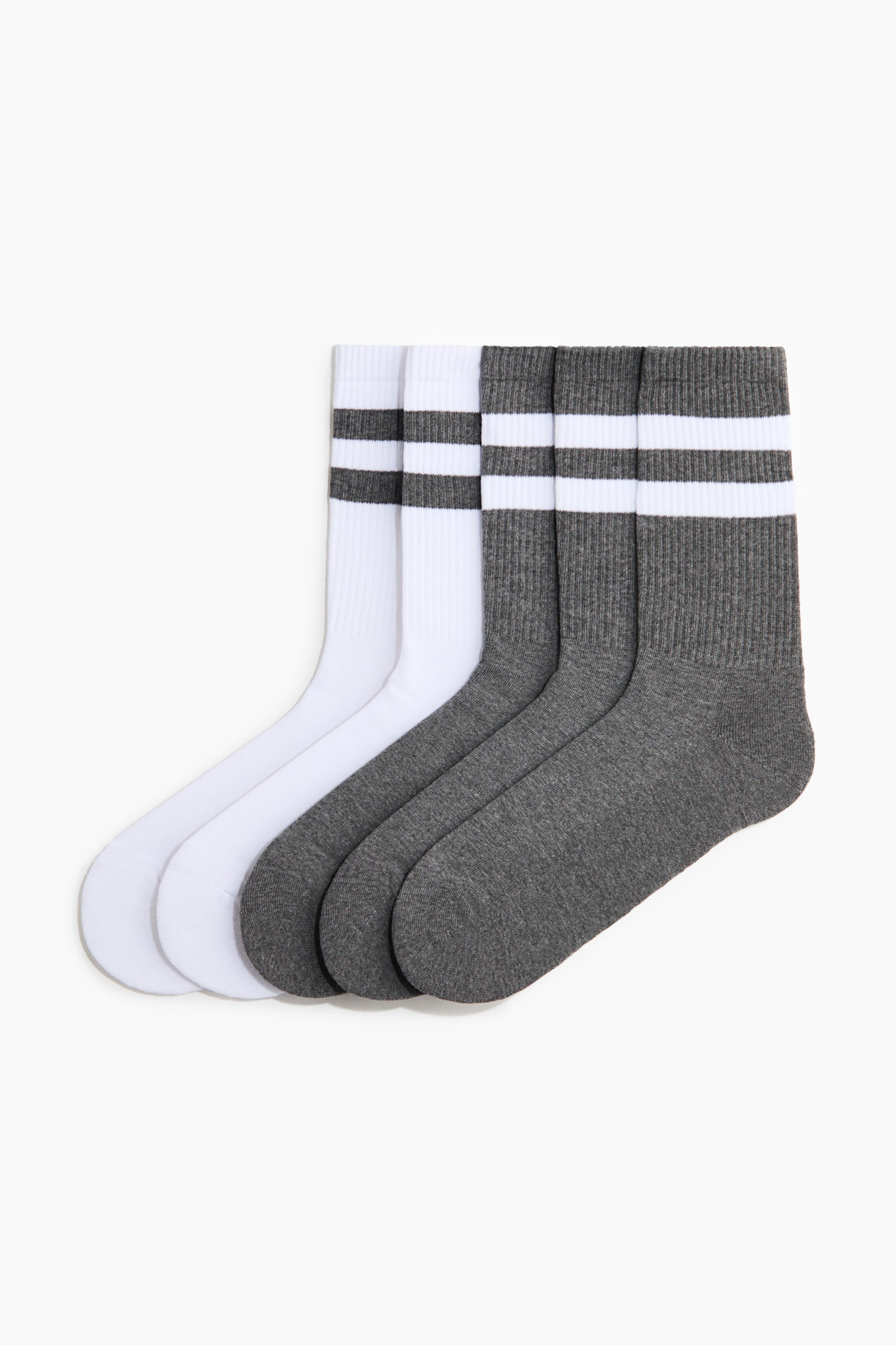 View larger image: Four socks are lying flat, angled from the top left to the bottom right. Two white socks are showcasing two horizontal grey stripes on their ribbed cuffs, and two dark grey socks are featuring two horizontal white stripes on their ribbed cuffs.