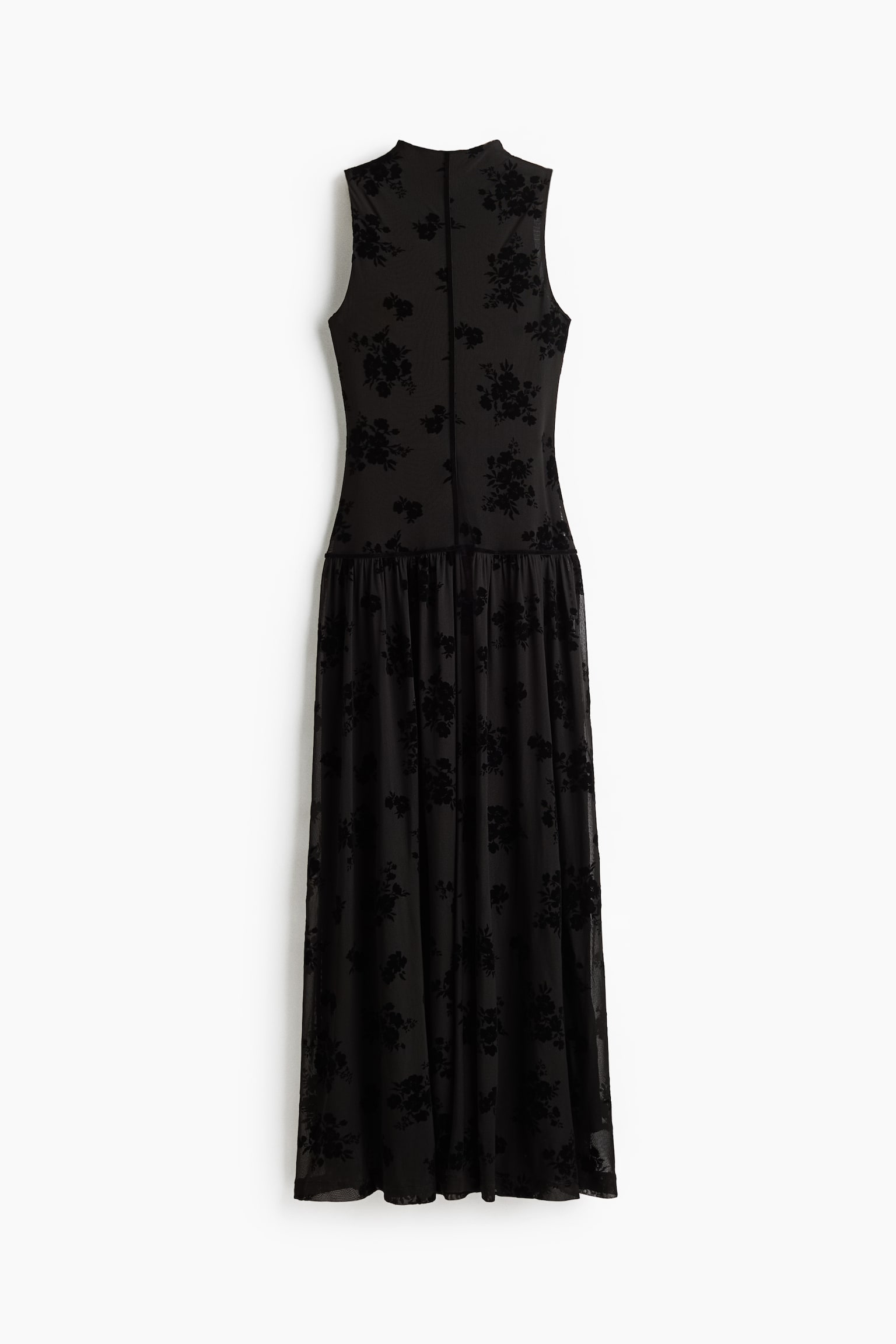 A black, sleeveless maxi dress features a high mock neck and a fitted bodice with a centre back seam. The dress features a sheer black mesh overlay with velvet floral flocking, transitioning into a gathered, flowing skirt at the dropped waist.