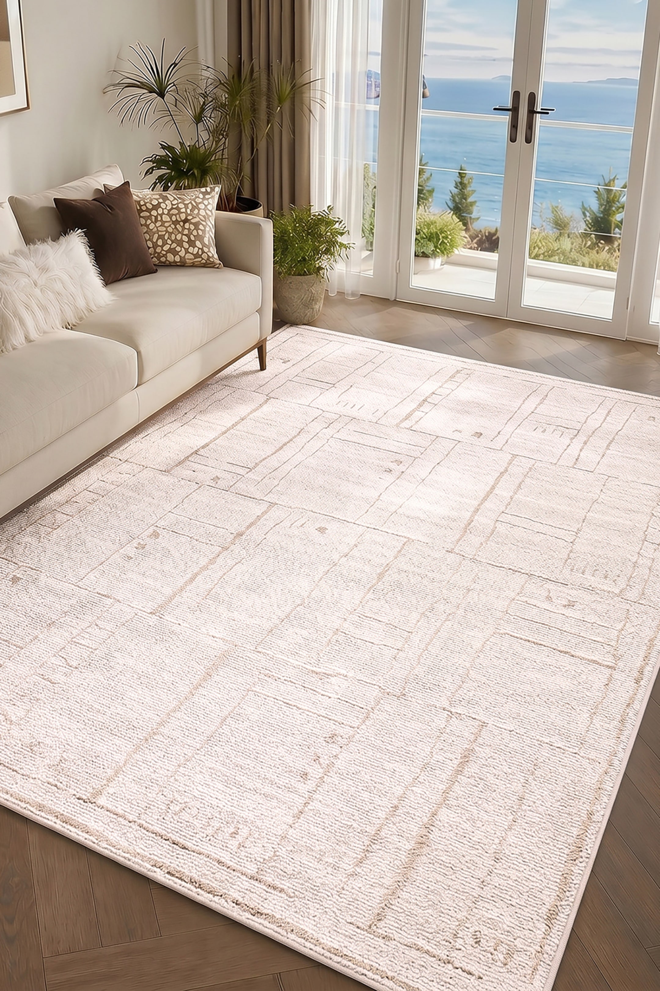 View larger image: This rectangular area rug showcases a textured, low-pile surface in cream and off-white, patterned with abstract, intersecting tan lines that form a geometric grid of rectangular blocks. The rug is presented from a high-angle perspective, highlighting its soft, woven texture and subtle colour variations.