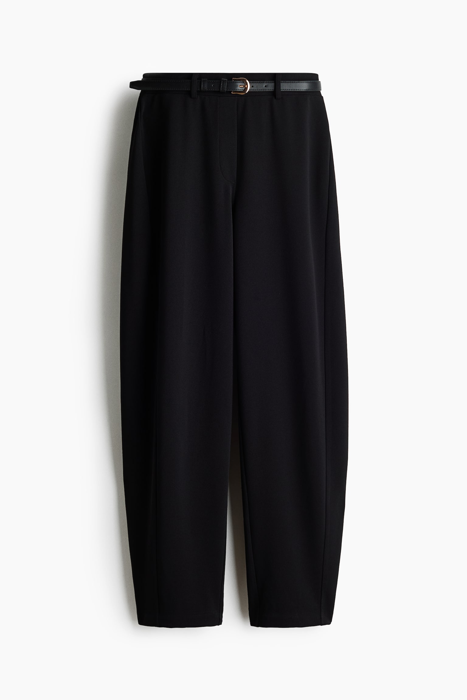 These black, high-waisted trousers are shown in a front view, highlighting a relaxed, slightly tapered leg silhouette. The trousers feature a thin black belt with a gold-tone buckle threaded through the belt loops at the waist.