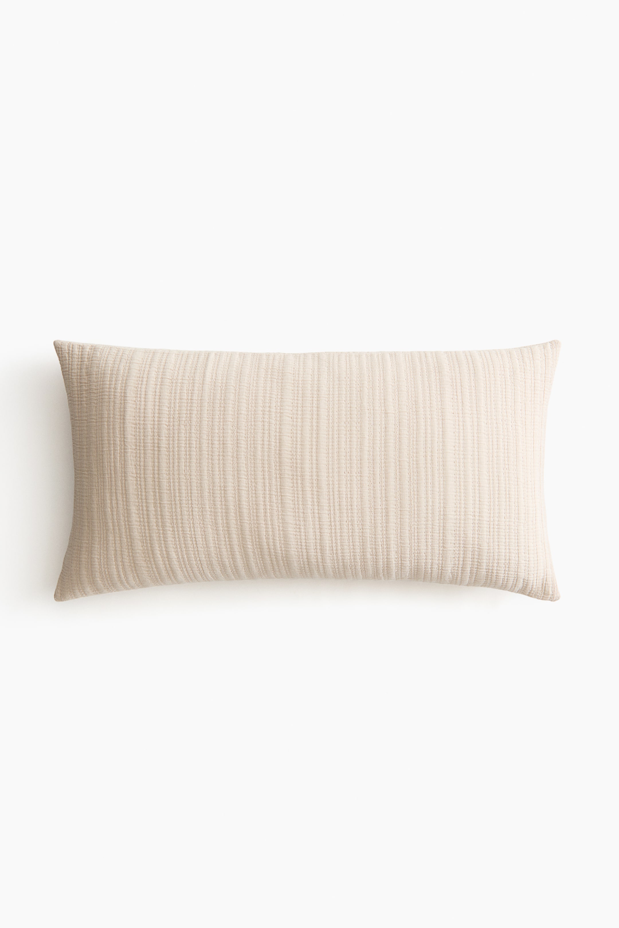 Voir une image plus grande: Un oreiller rectangulaire est posé à plat, affichant une couleur beige clair et une surface texturée avec de subtiles nervures verticales.