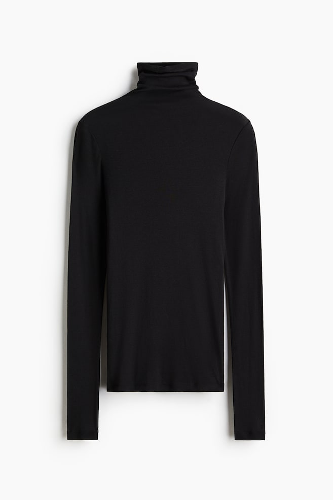 A black jersey top is being presented from the FRONT, featuring a rolled turtleneck and extra-long fitted sleeves. - 1