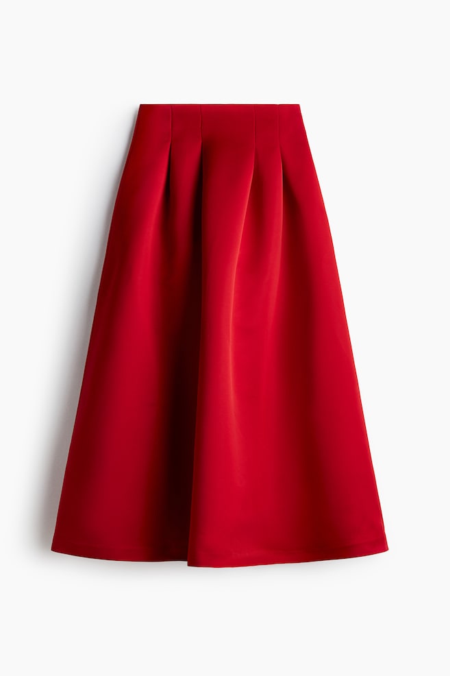 A red midi skirt is presented front-facing, featuring a flat waistband and wide box pleats that are creating a voluminous A-line silhouette. - 1