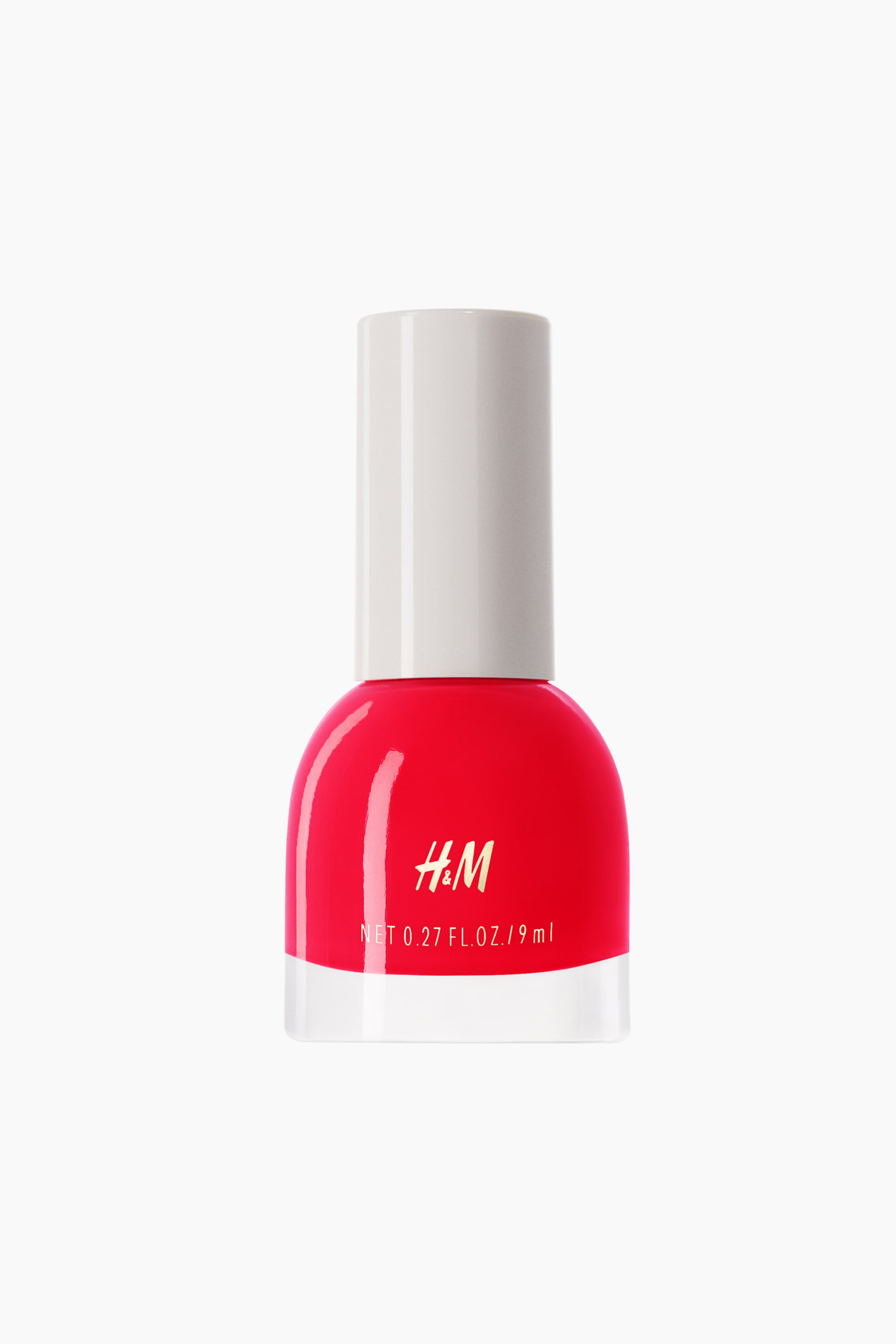 View larger image: The H&M red nail polish bottle showcases a rounded body with a transparent base and a white cylindrical cap. The front displays the H&M logo and the product volume.