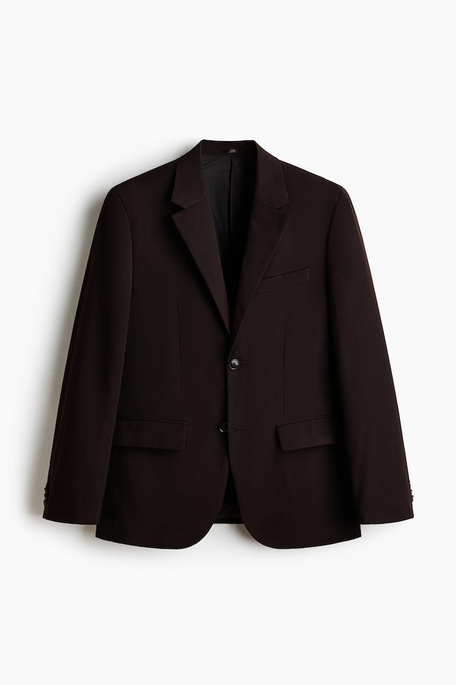 A dark brown blazer is presenting front-facing, featuring notch lapels and a two-button closure. It is displaying two flap pockets at the hips, a single welt chest pocket, and buttoned cuffs, with black lining visible at the collar. - 1