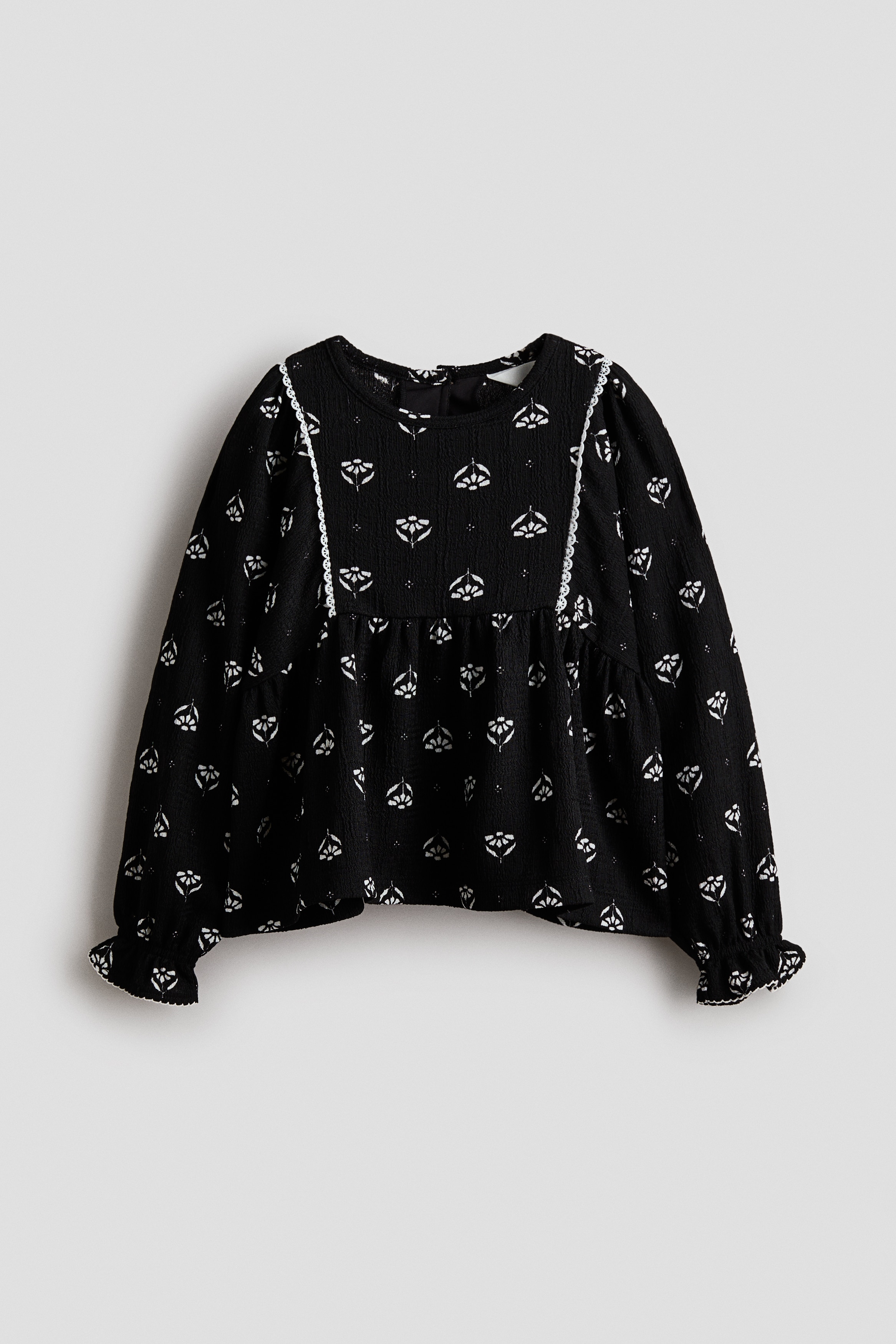 Strukturmönstrad blus i trikå - Svart/Blommig/Vit