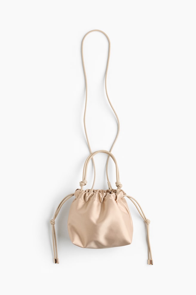 Îια μικÏή, μÏεζ ÏαÏÎν ÏÏάνÏα crossbody κÏÎμεÏαι Ïε μÏÏοÏÏινή ÏÏη, αναδεικνÏονÏÎ±Ï Îνα μαζεμÎνο κλείÏιμο με κοÏδÏνι και ανÏίÏÏοιÏα κοÏδÏνια με μεÏαλλικÎÏ Î¬ÎºÏÎµÏ Ïε ÏÏÏ
ÏαÏί αÏÏÏÏÏÏη. Î ÏÏάνÏα ÏαÏοÏ
Ïιάζει διÏλά εÏÎ¬Î½Ï ÏεÏοÏλια με λεÏÏομÎÏÎµÎ¹ÎµÏ Î±ÏÏ ÎºÏμÏο ÏÏη βάÏη και Îνα μακÏÏ, ÏÏÎµÎ½Ï Î»Î¿Ï
Ïί ÏμοÏ
ÏοÏ
εκÏείνεÏαι ÏÏÎ¿Ï Ïα ÏάνÏ. - 1