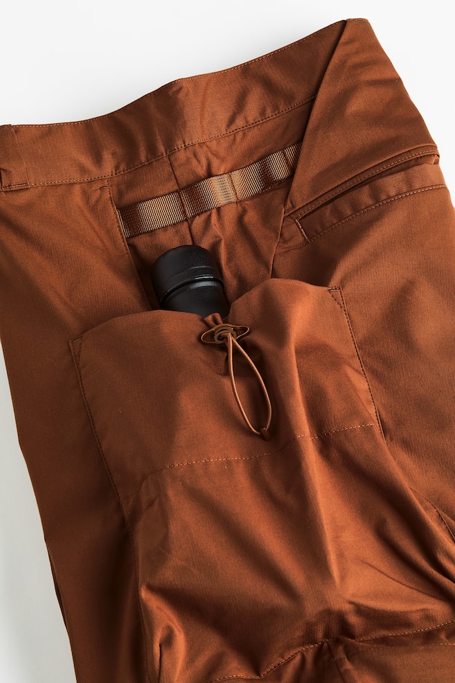 Water-repellent zip-off hiking trousers - Brown/Black - 8