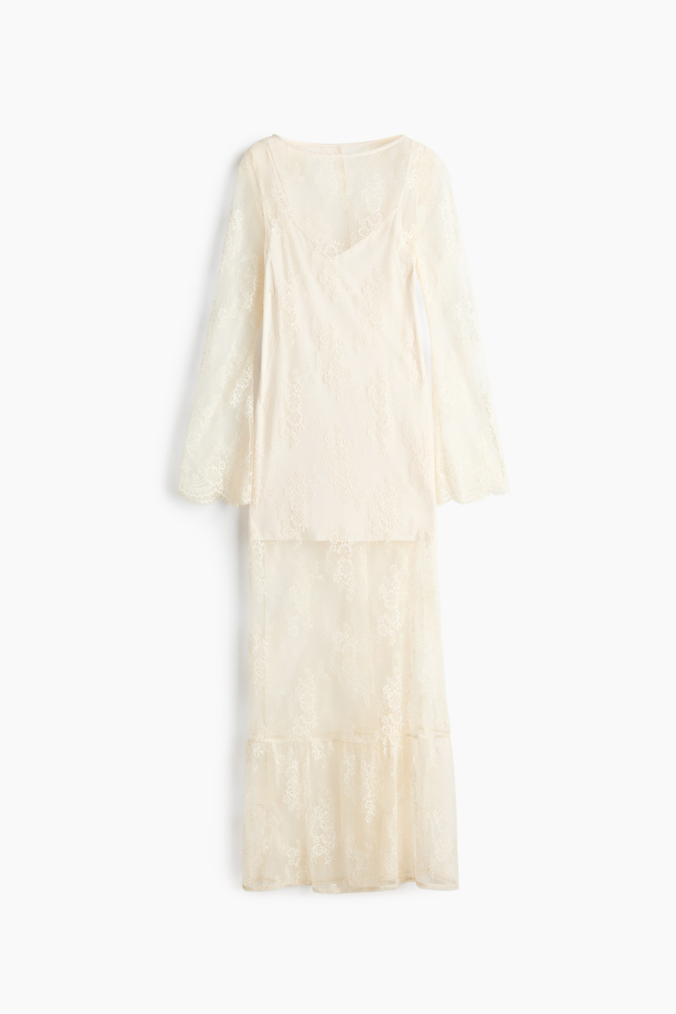 View larger image: A cream lace two-piece set is showcased from the front, highlighting a top with a V-neckline and long, flared sheer sleeves, layered over an opaque bodice. The coordinating maxi skirt completes the ensemble, featuring a tiered design with a ruffled hem and layered over an opaque underlayer.