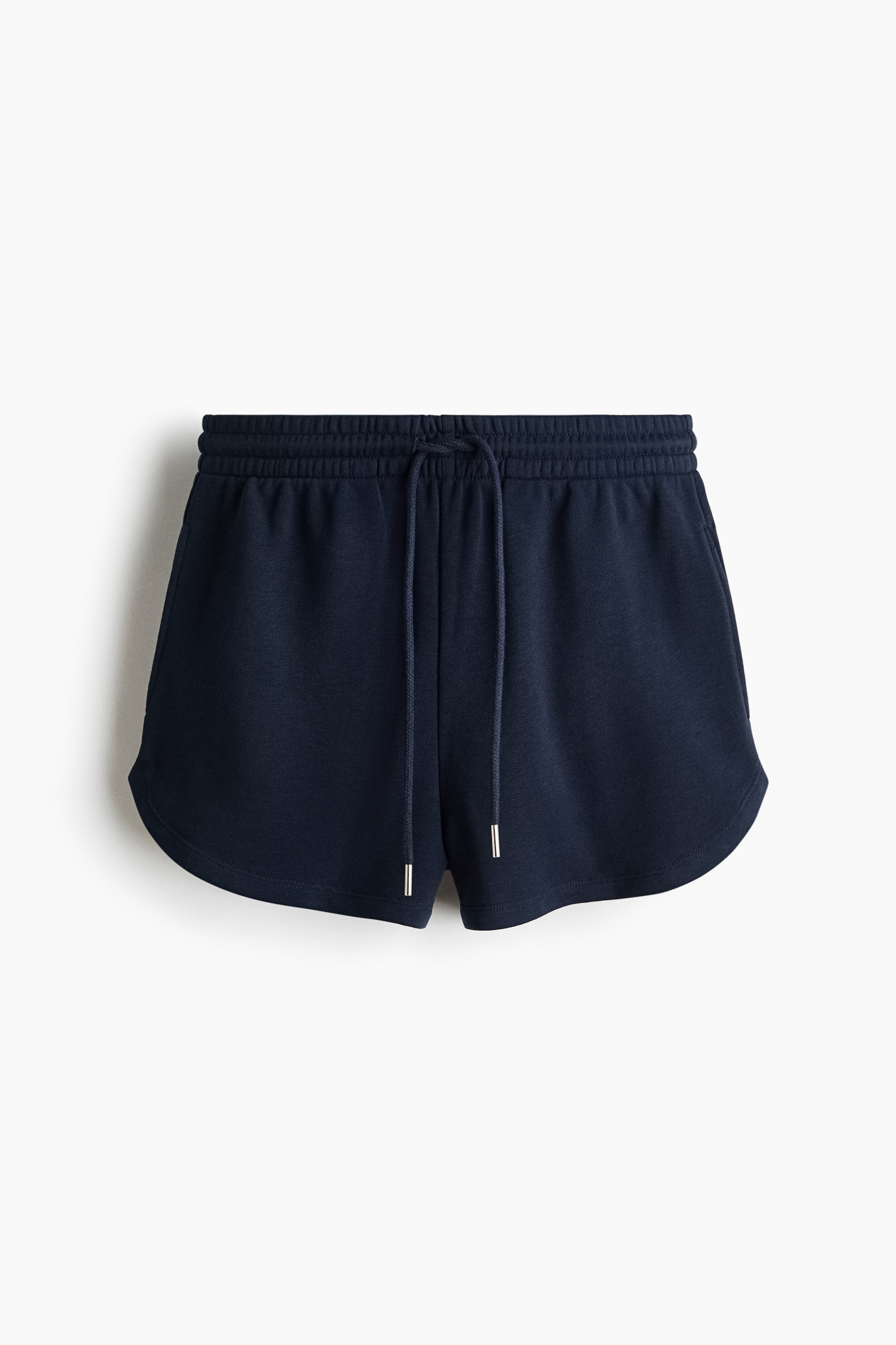 View larger image: Dark blue sweatshirt shorts are shown from the front, showcasing a covered elasticated waist with a knotted drawstring and silver-toned aglets. They are crafted with discreet side pockets and a curved hemline.