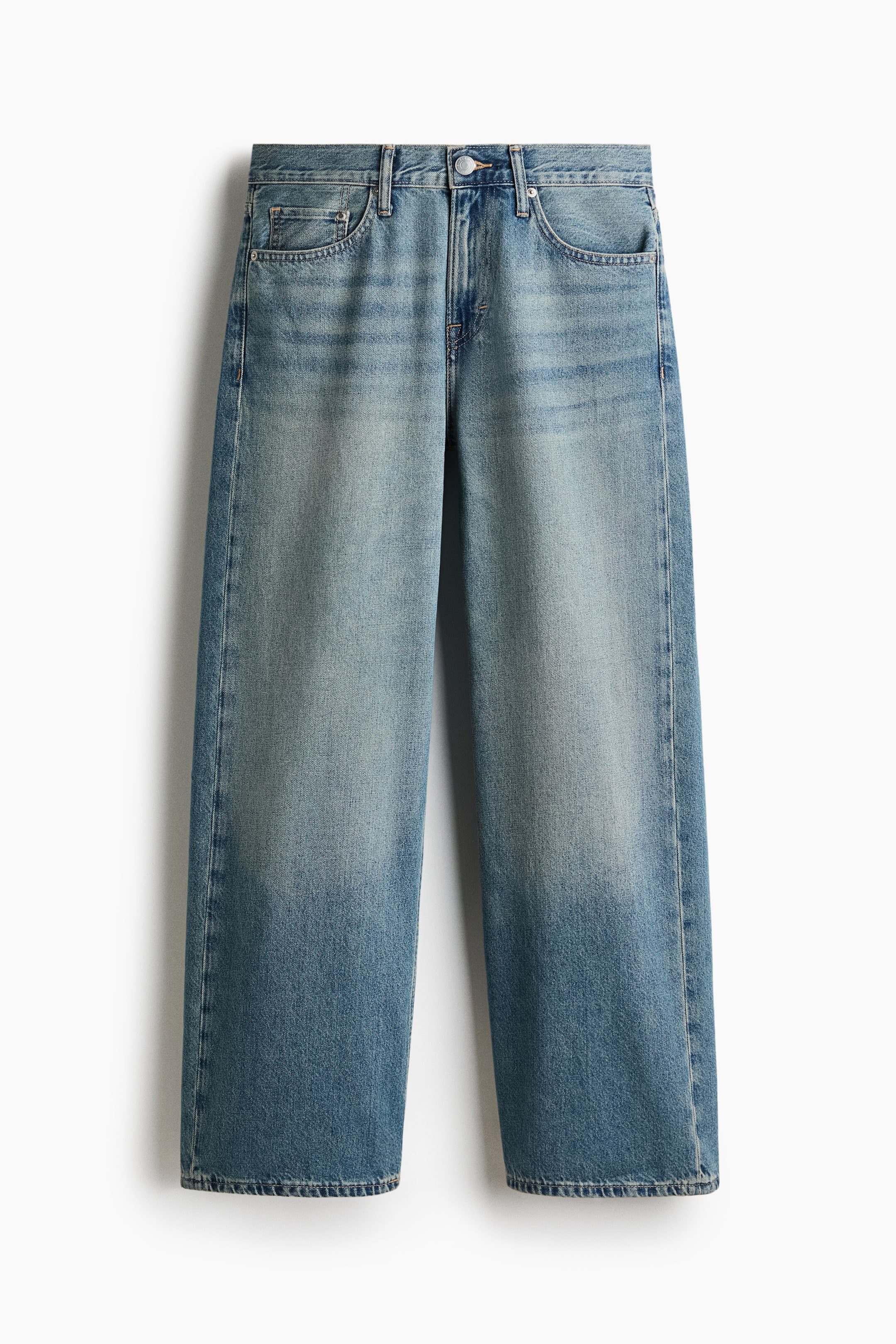 View larger image: A pair of five-pocket jeans is laid out flat, showcasing a medium blue wash with lighter fading on the thighs. It features a regular waist, a button fly, and a wide, straight leg with a relaxed fit throughout.