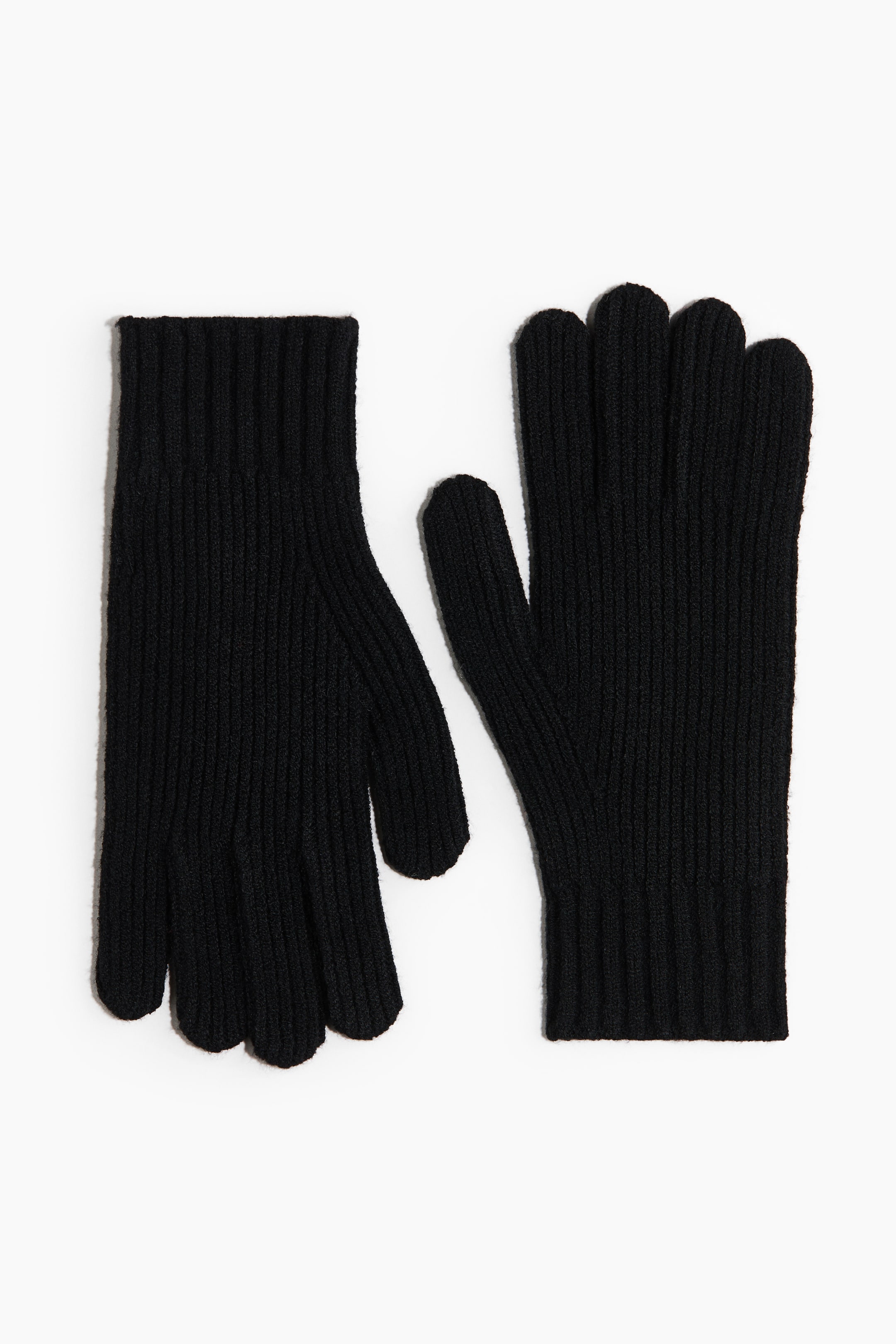 View larger image: A pair of black gloves is lying flat, side by side, showing a consistent ribbed knit texture across their five fingers and wrist cuffs.
