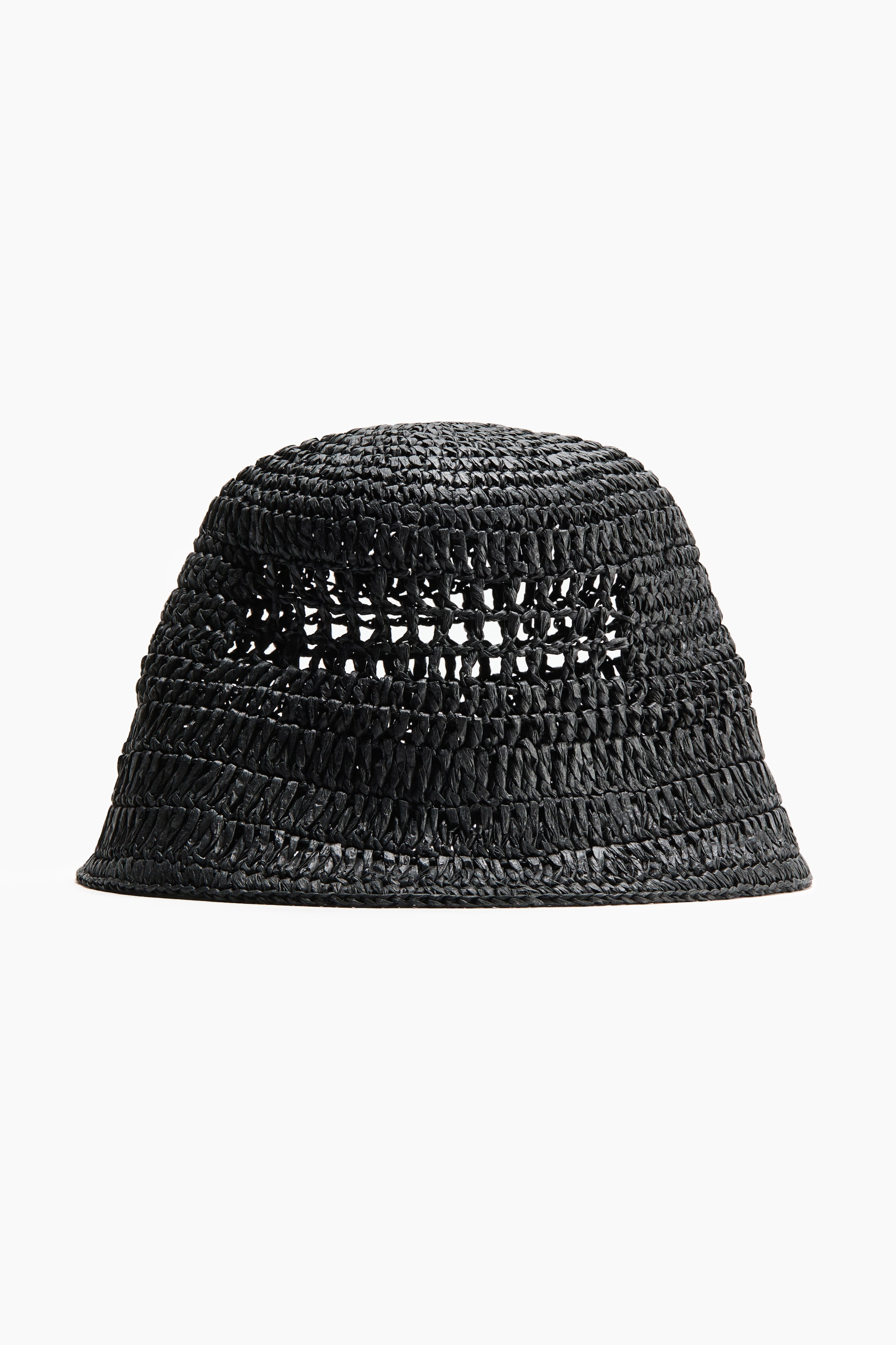 View larger image: A black braided paper straw bucket hat is shown from the front. It features a rounded crown and a narrow, slightly downturned brim, with the open-weave braiding creating small visible holes around the crown.