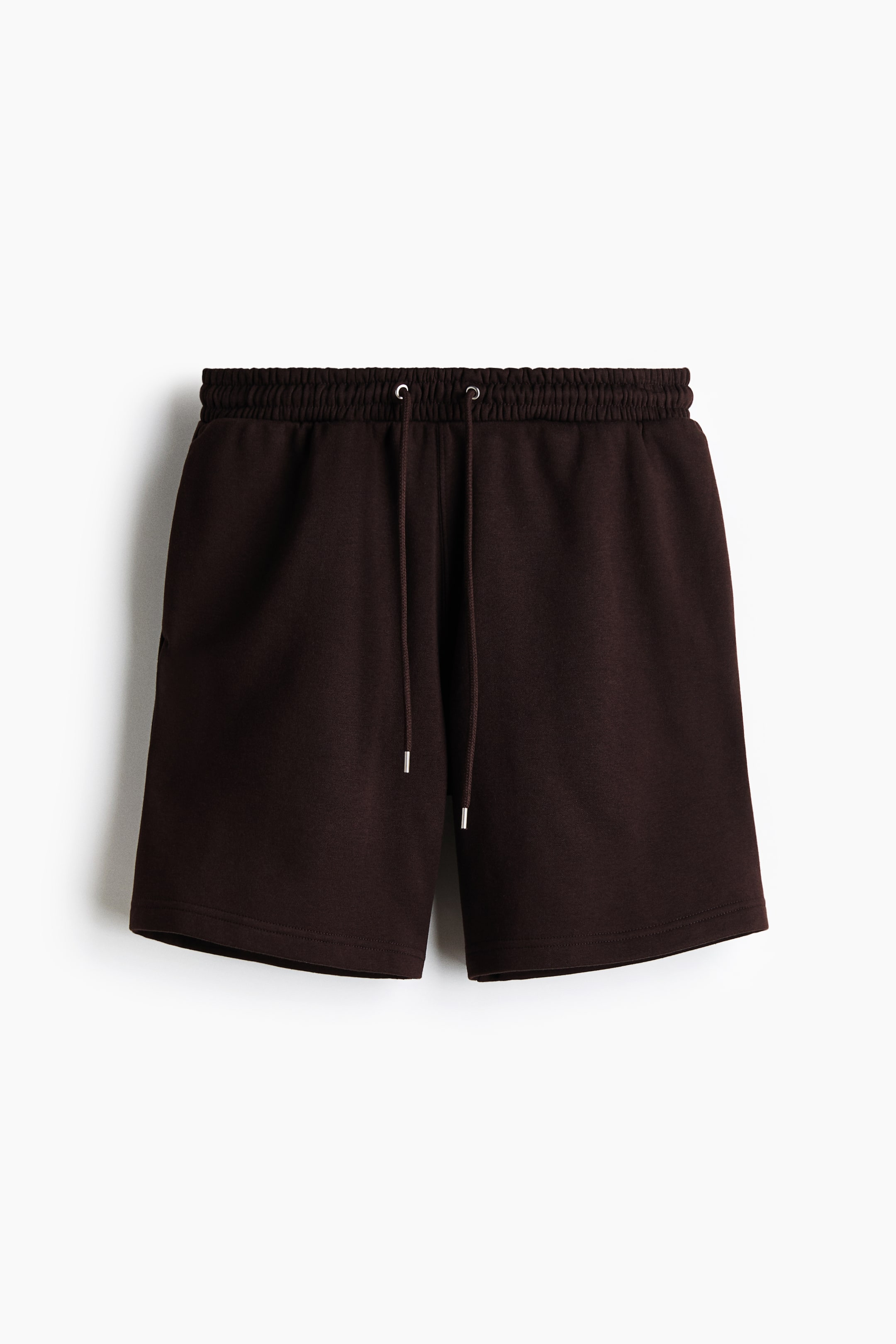 View larger image: Dark brown jersey shorts are shown from the front. They feature an elastic waistband with a visible drawstring detailed with silver-toned metal tips, and subtle side pockets.