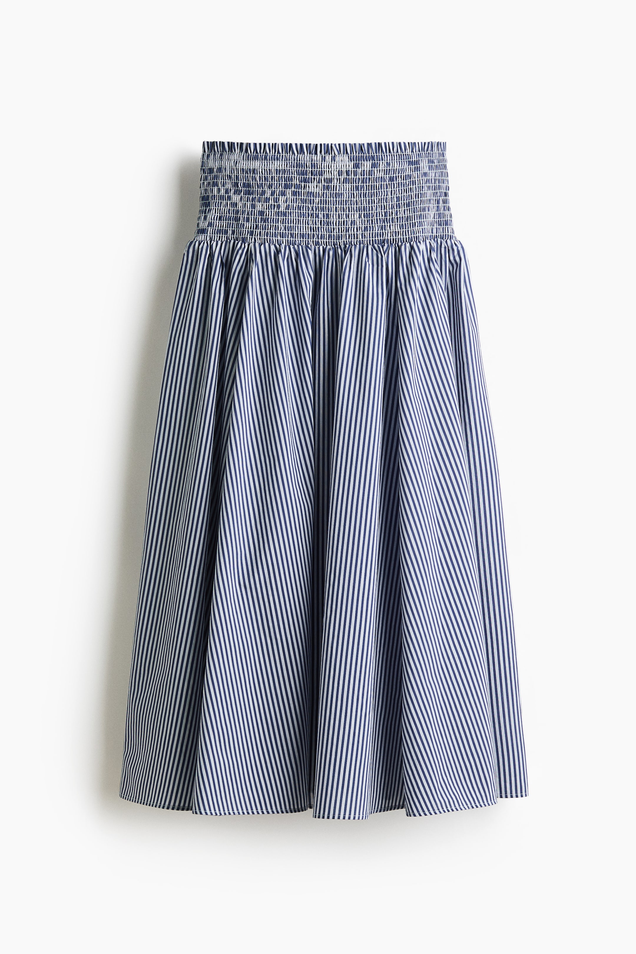 View larger image: A blue-and-white striped skirt is presented front-facing, featuring a wide, shirred waistband. The gathered A-line body displays vertical blue-and-white stripes.