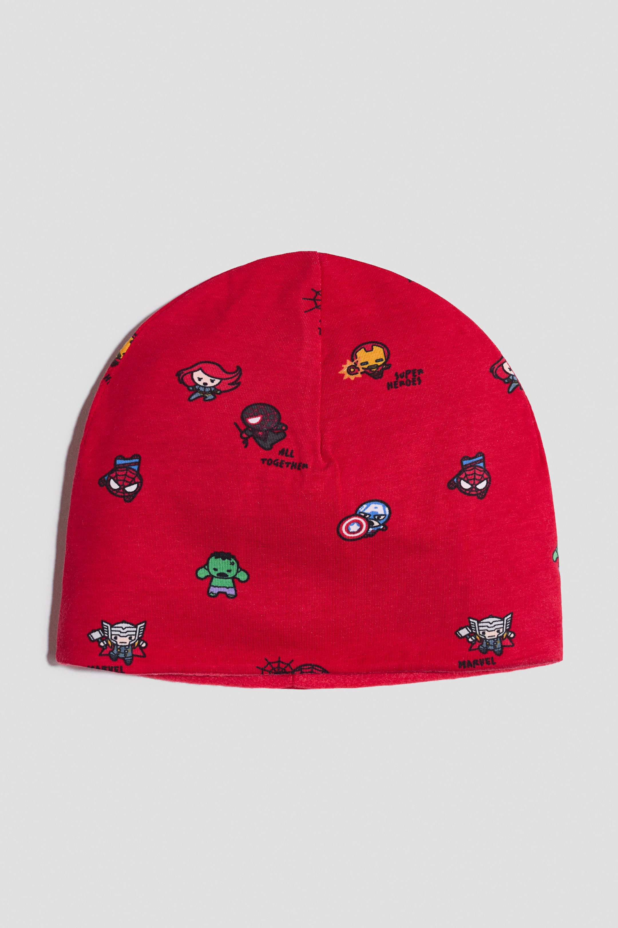 View larger image: A red knit beanie features an all-over print of various cartoon Marvel characters, including Spider-Man, Iron Man, Hulk, and Captain America. It presents a rounded crown and a finished bottom edge in a front view.