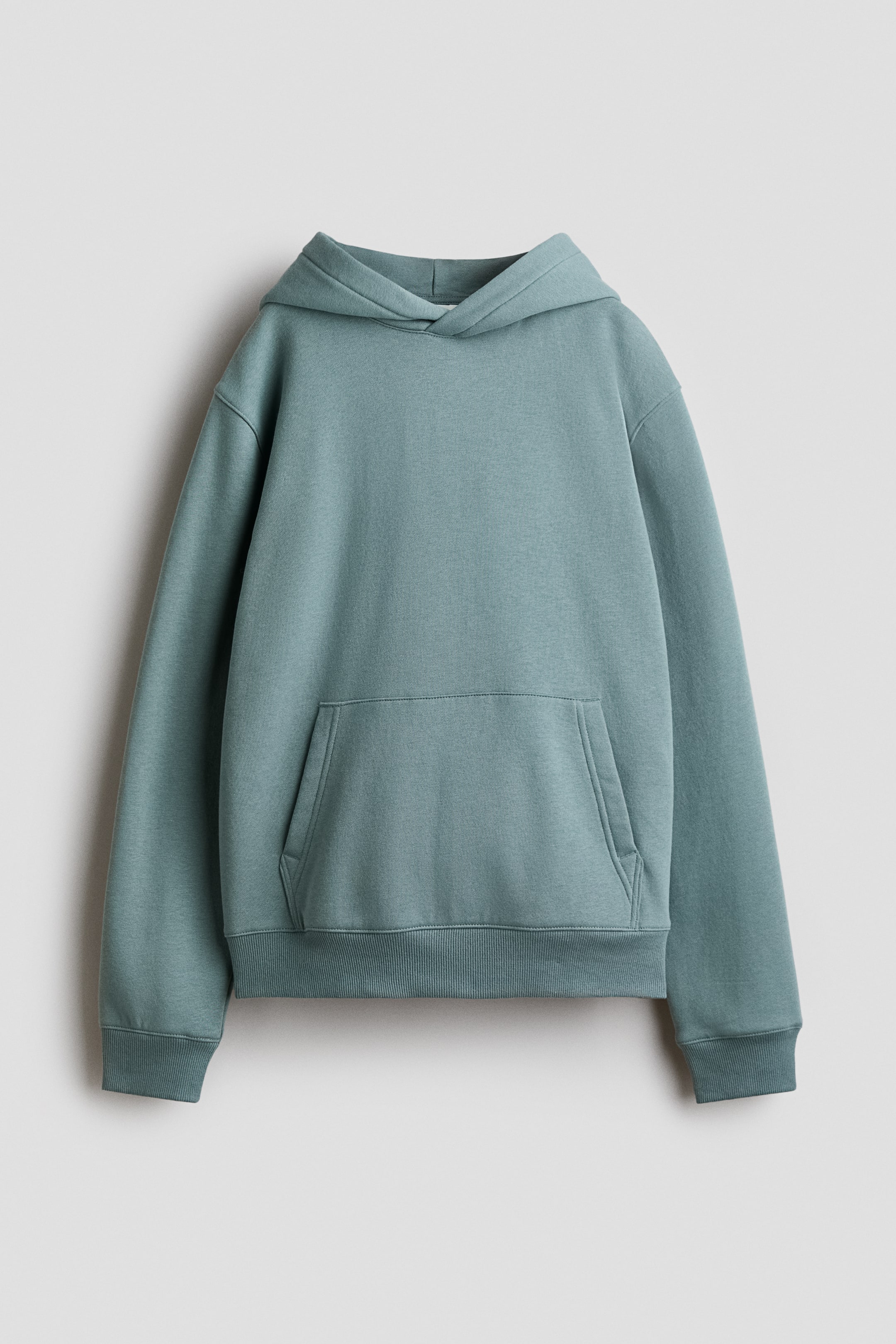 View larger image: A smooth teal hoodie is shown from the front, featuring an attached hood, a kangaroo pocket on the front, and ribbed cuffs and hem.