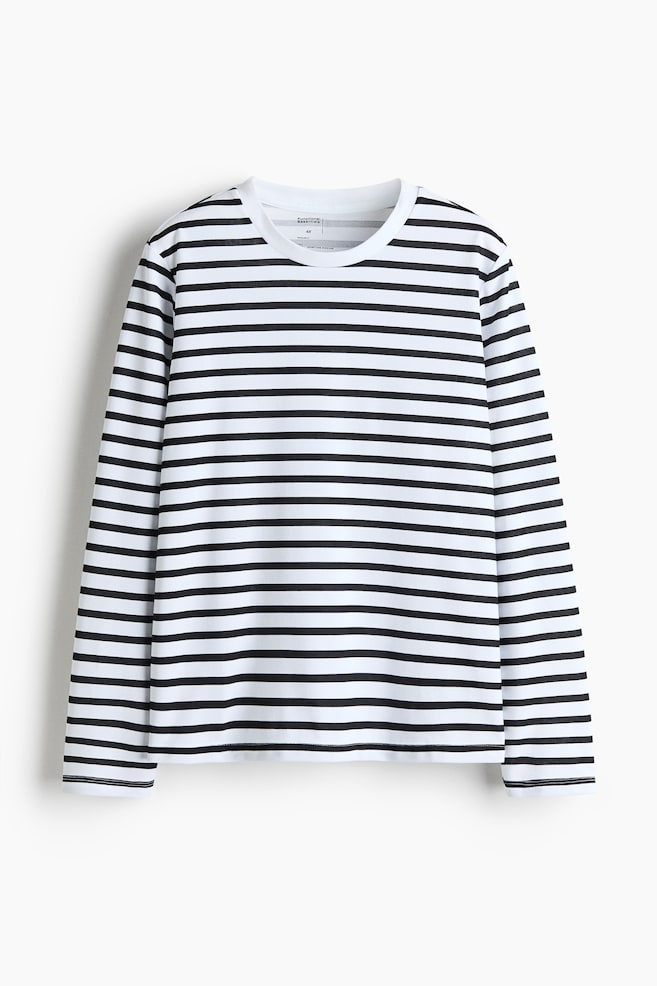 A long-sleeved top is facing front, displaying a pattern of horizontal black and white stripes. It features a round neckline, long sleeves, and a straight-cut hem. - 1