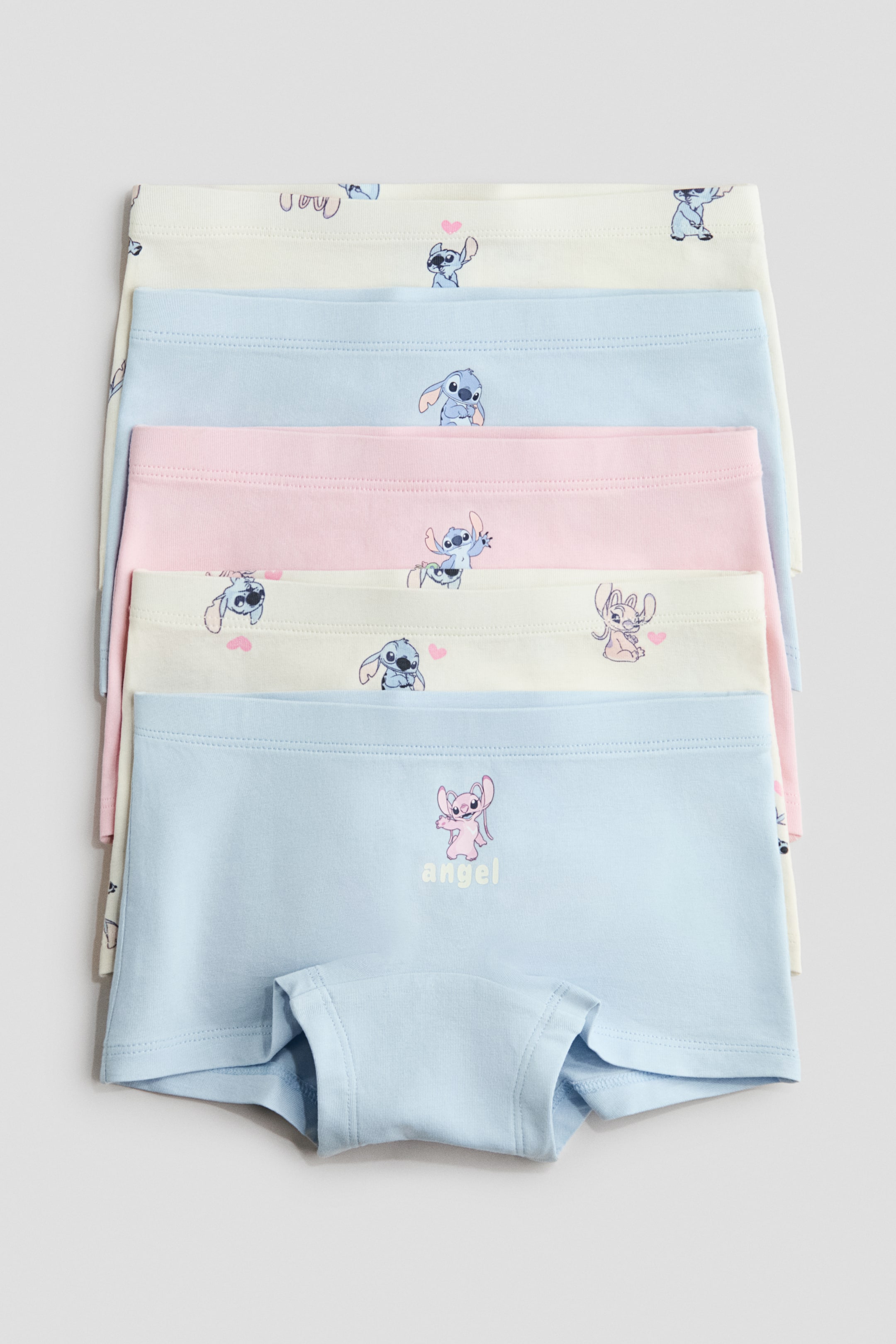 View larger image: Five pairs of printed cotton jersey boxer briefs are stacked, showcasing cartoon character designs in pastel hues. The front of the bottommost light blue brief highlights its elasticated waistband and lined gusset.