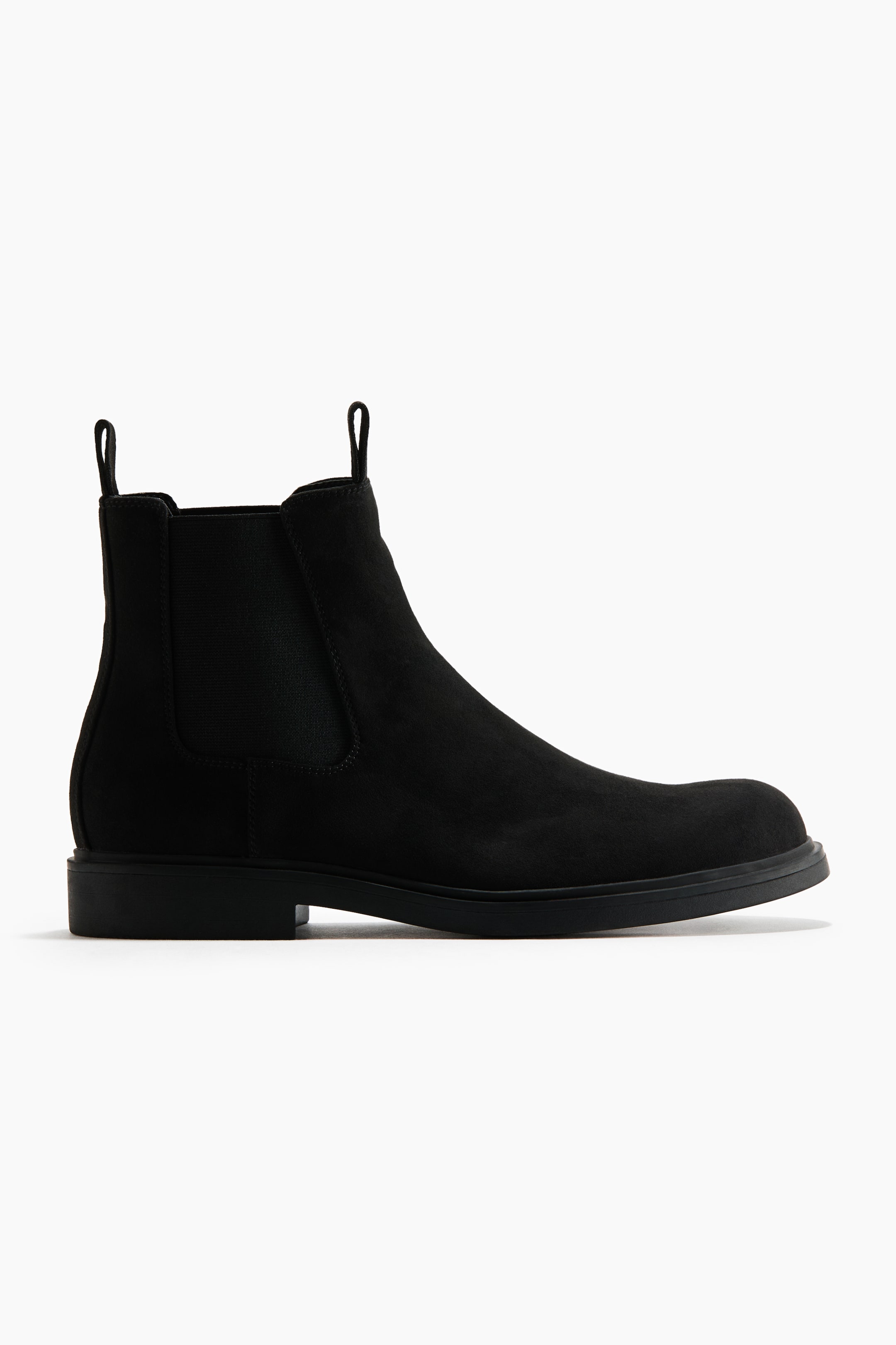 View larger image: A black Chelsea boot is shown in side profile, featuring a coated fabric upper, elastic side gores, and pull tabs at the front and back. It is finished with chunky soles.